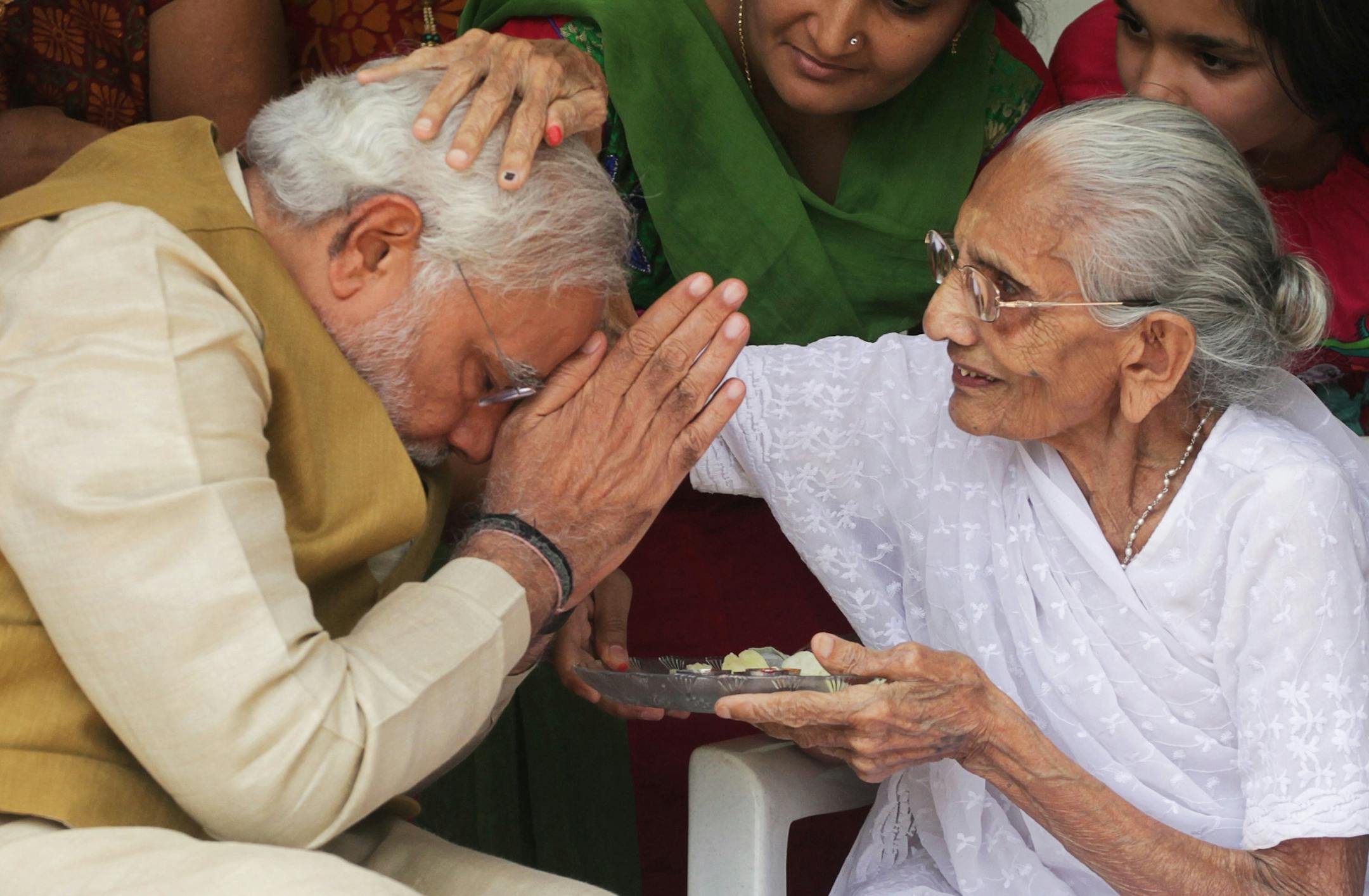 90-year-old Hiraben blesses her son and India's next prime minister Narendra Modi at her home in Gandhinagar, in the western Indian state of Gujarat, Friday, May 16, 2014. The top official in Gujarat state for over a decade, Modi often contrasted his humble roots with the posh background of his main rival, 43-year-old Rahul Gandhi, heir to India's most powerful political dynasty. As the career politician led his party through a dazzling, high-tech election campaign, Modi called voters' attention