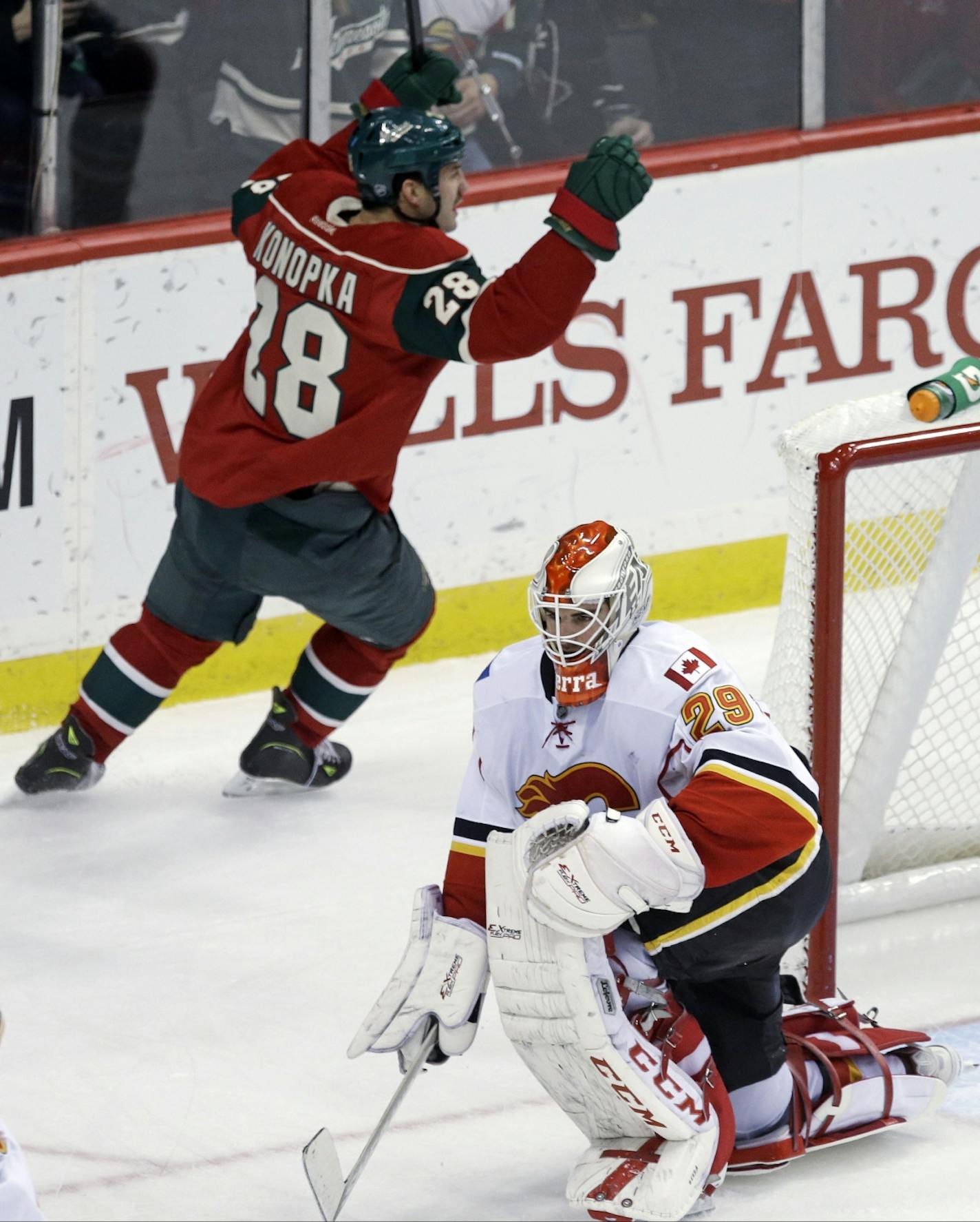 Minnesota Wild's Zenon Konopka (28) celebrates his goal against Calgary Flames goalie Reto Berra in the third period of an NHL hockey game, Tuesday, Nov. 5, 2013, in St. Paul, Minn. The Wild won 5-1.