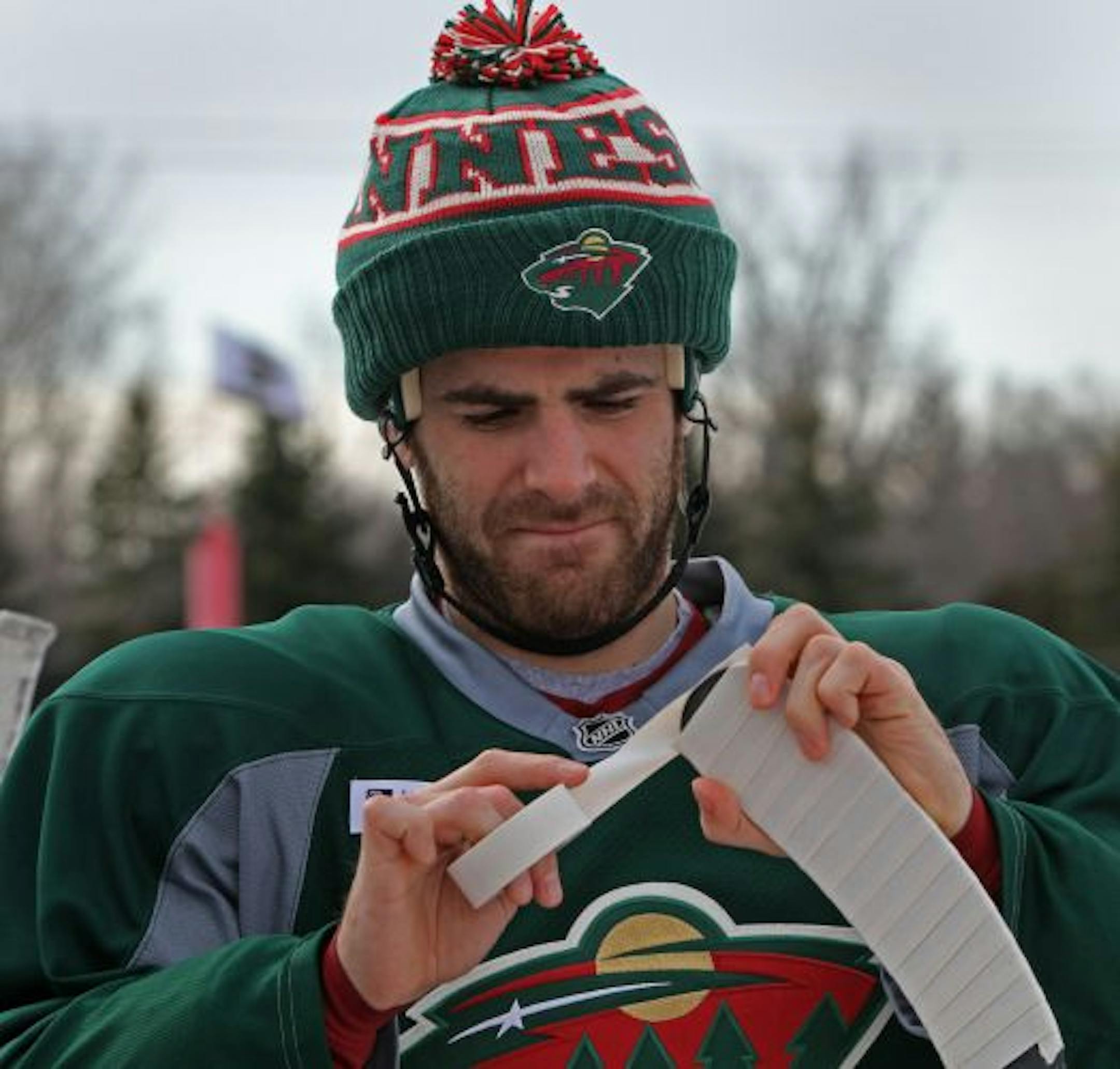 Minnesota Wild forward Eric Nystrom taped his stick before hitting the ice Saturday for the Wild's first outdoor practice at the John Rose Oval in Roseville. Hundreds of hockey fans turned out to see the team and get autographs.