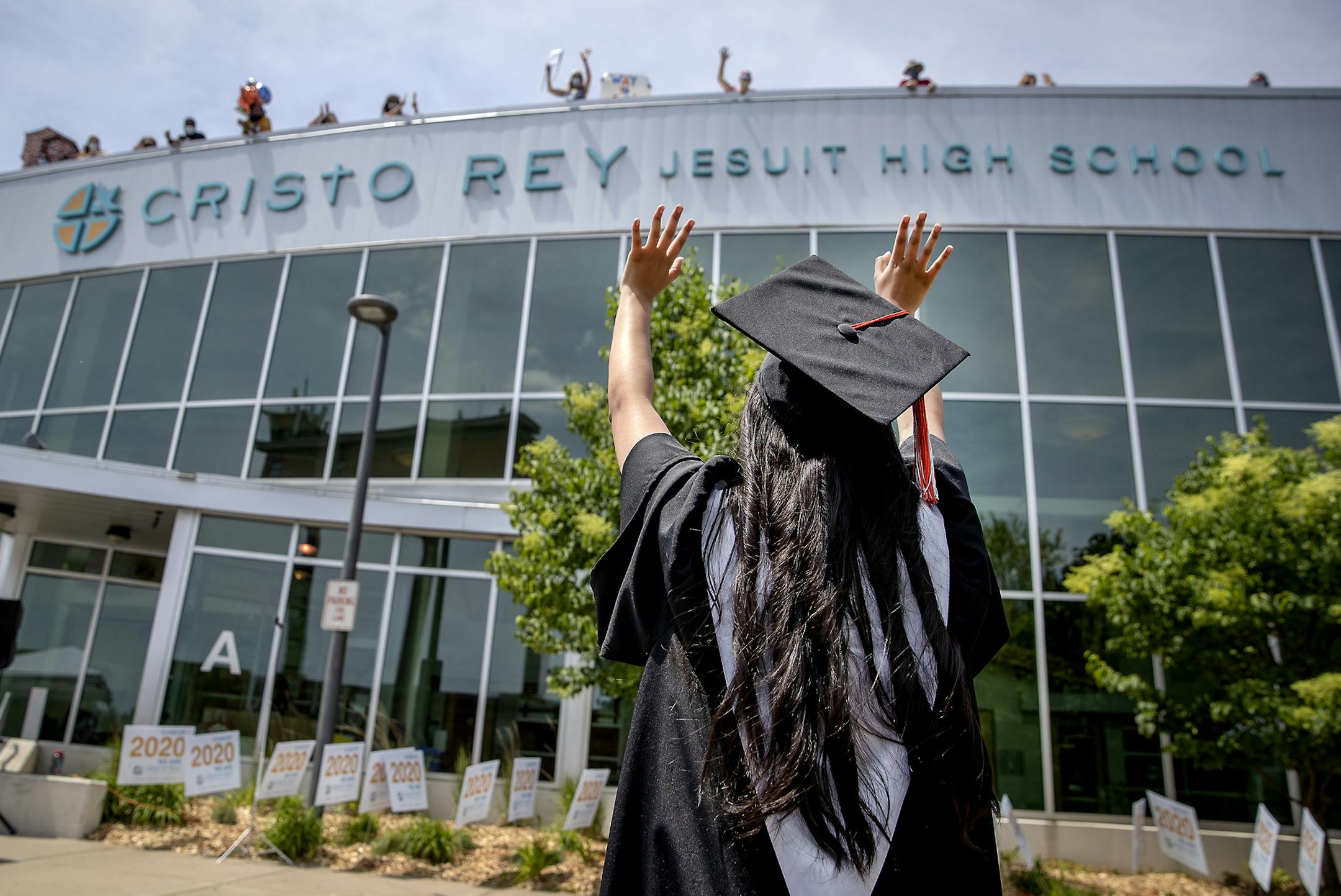 Cristo Rey Jesuit High School graduate Maria Medel waved goodbye to her teachers who cheered from the school's roof during their drive-thru commencement celebration, Saturday, June 6, 2020 in Minneapolis, MN. The school, located in the heart of the unrest, only had four windows broken. Cristo Rey graduated a class of 124. ] ELIZABETH FLORES • liz.flores@startribune.com