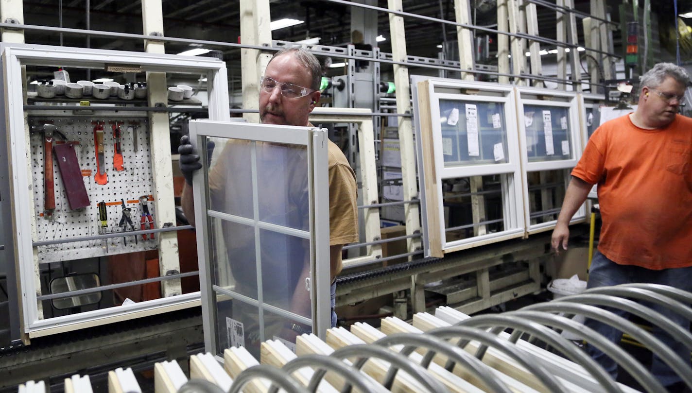 Andersen Windows assembly workers Mike Rowley, left, and Kevin Krenz installed sashes in double-hung frames on Wednesday at the Bayport plant.