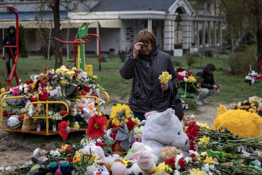 A woman prays at a makeshift memorial in Kryvyi Rih, Ukraine, on April 6, 2025, where a Russian strike on Friday killed 19 people, including nine children. A Russian missile strike near a playground in central Ukraine killed 19 people, including nine children. The attack was a painful reminder that a cease-fire remains as distant as ever.