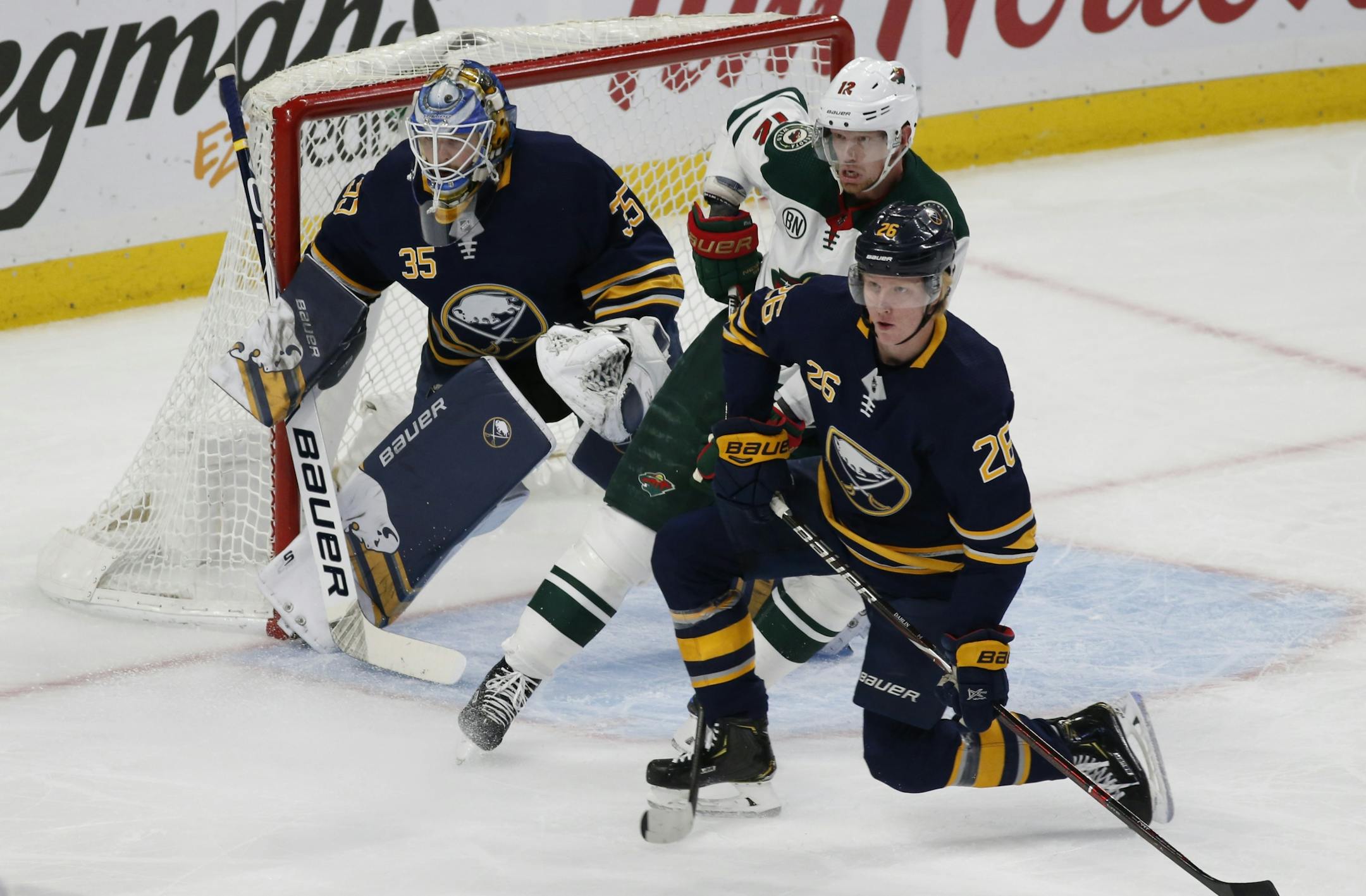 Buffalo Sabres defenseman Rasus Dahlin (26) and Minnesota Wild forward Eric Staal (12) battle in front goalie Linus Ullmark (35) during the first period of an NHL hockey game, Tuesday, Feb. 5, 2019, in Buffalo N.Y.