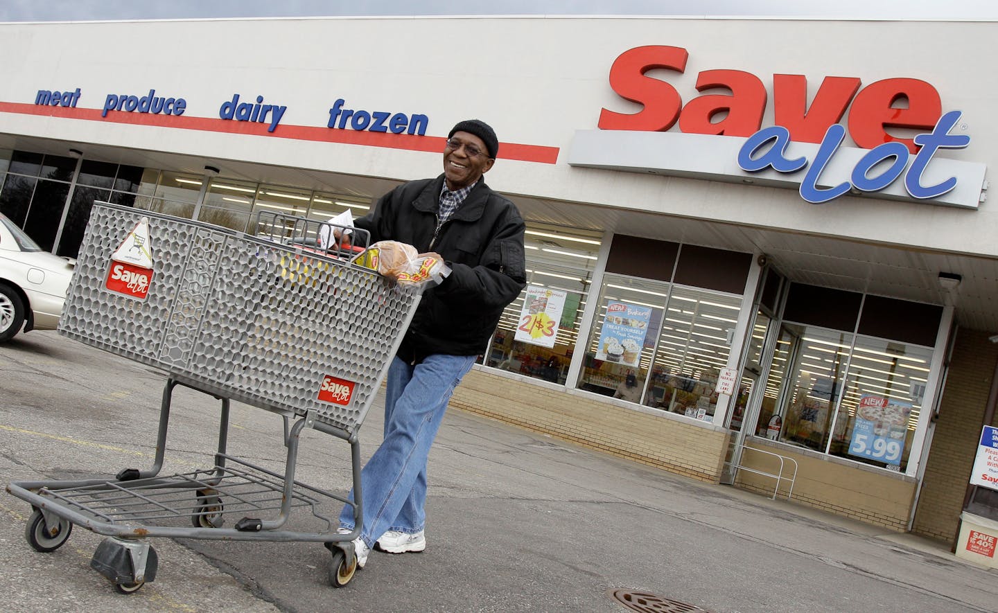 In this April 12, 2011 photo, shopper Andrew Boston leaves the Save-a-Lot grocery store with his purchases in Northfield, Ohio. Grocer Supervalu Inc.'s fiscal fourth-quarter net income dipped 2 percent Thursday, April 14, 2011, partly weighed down by softer sales and store closings.(AP Photo/Amy Sancetta)