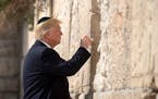 President Donald Trump places a paper into the Western Wall in Jerusalem, May 22, 2017. Trump began a two-day visit to Israel and the West Bank Monday