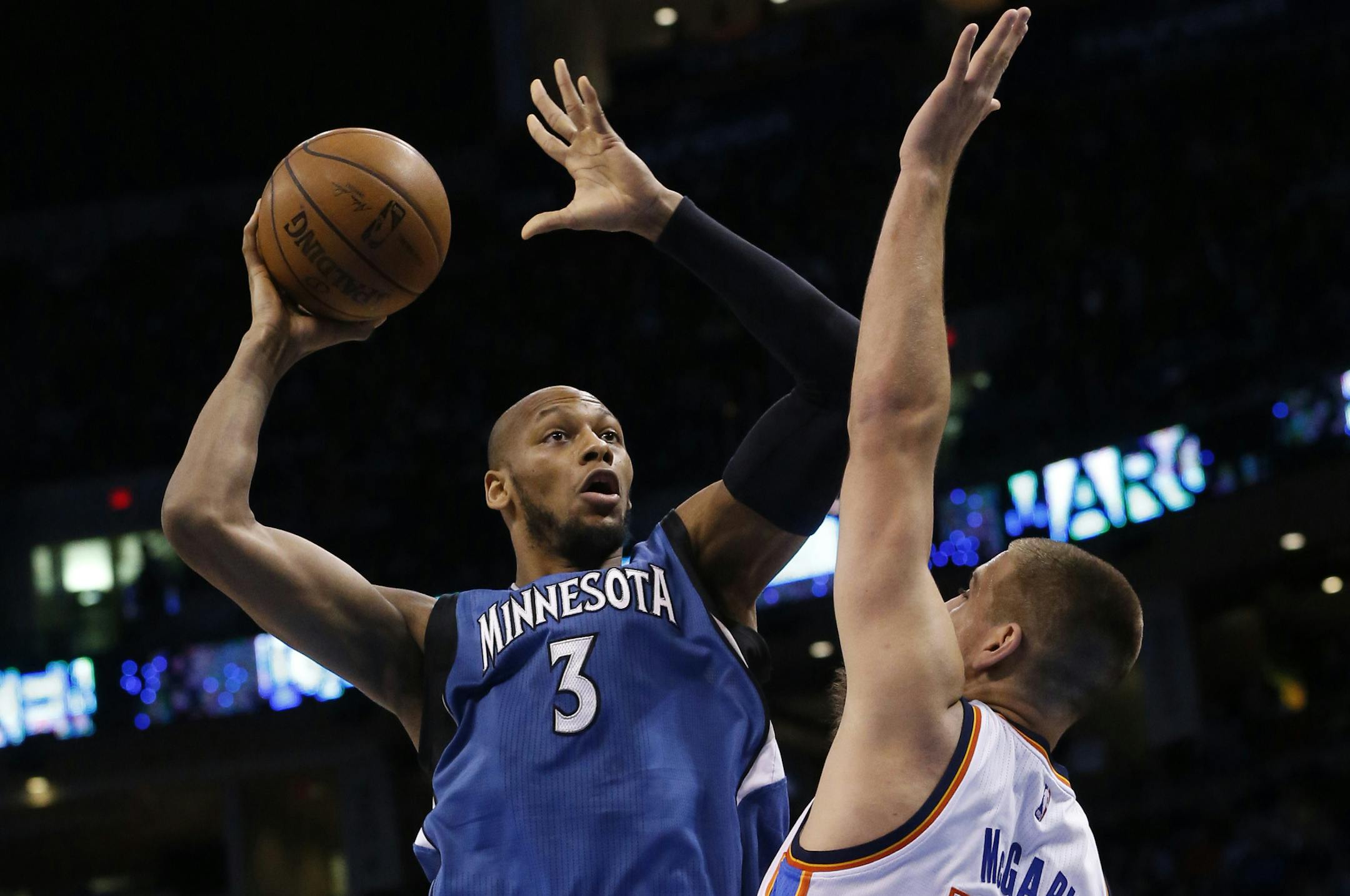 Minnesota Timberwolves forward Adreian Payne (3) shoots as Oklahoma City Thunder forward Mitch McGary (33) defends during the first quarter of an NBA basketball game in Oklahoma City, Friday, March 13, 2015. (AP Photo/Sue Ogrocki)
