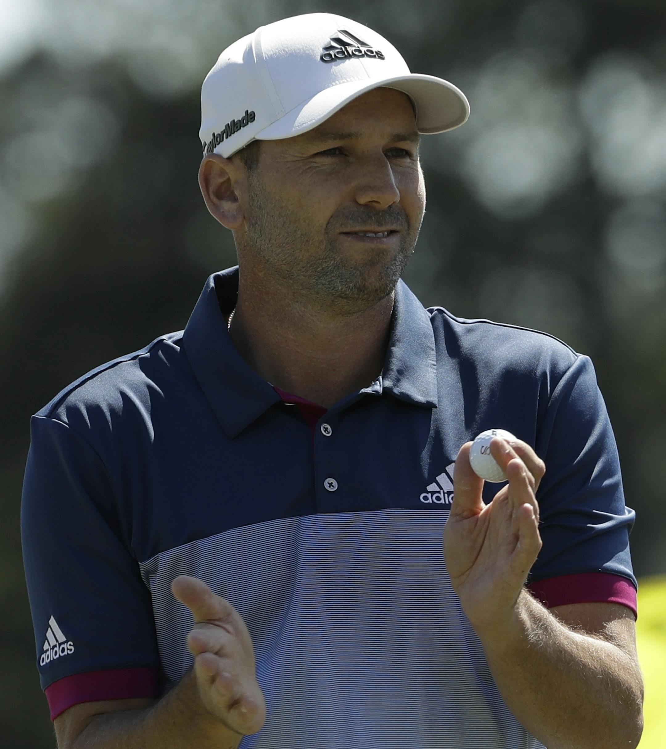 Sergio Garcia, of Spain, claps after putting on the 18th green during the second round of the Masters golf tournament Friday, April 7, 2017, in Augusta, Ga. (AP Photo/David J. Phillip)