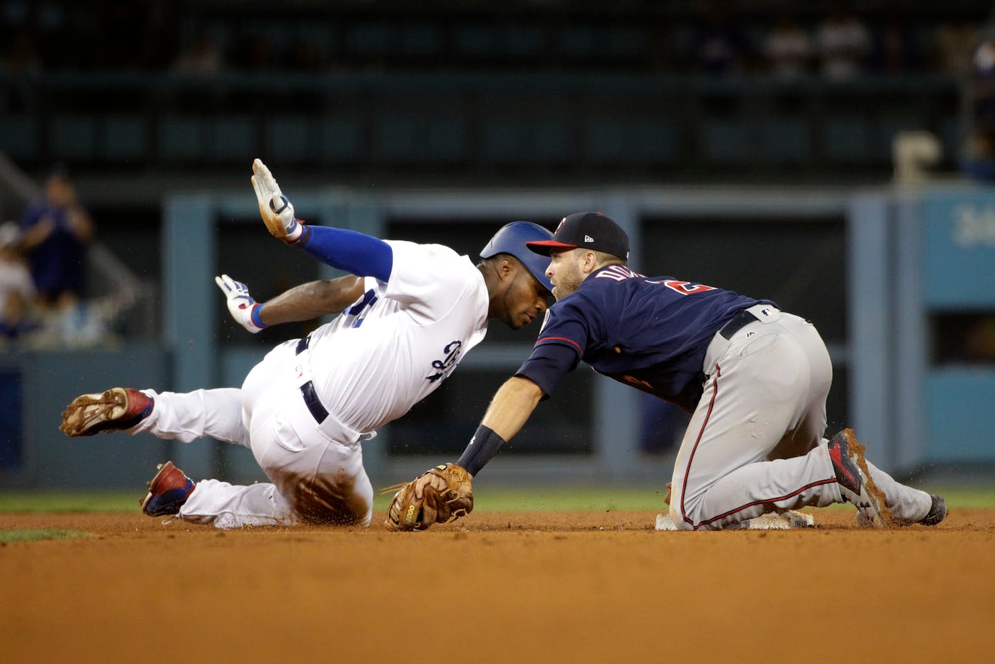 Los Angeles Dodgers' Yasiel Puig, left, is tagged out by Minnesota Twins' Brian Dozier during the sixth inning of a baseball game, Tuesday, July 25, 2017, in Los Angeles. (AP Photo/Jae C. Hong)