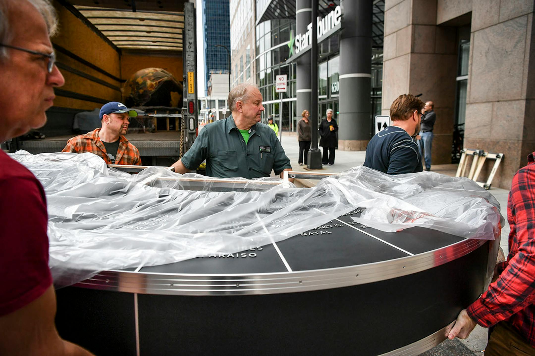 Workers from Blue Rhino Studio in Eagan handled the restoration and placement of the Star Tribune globe.
