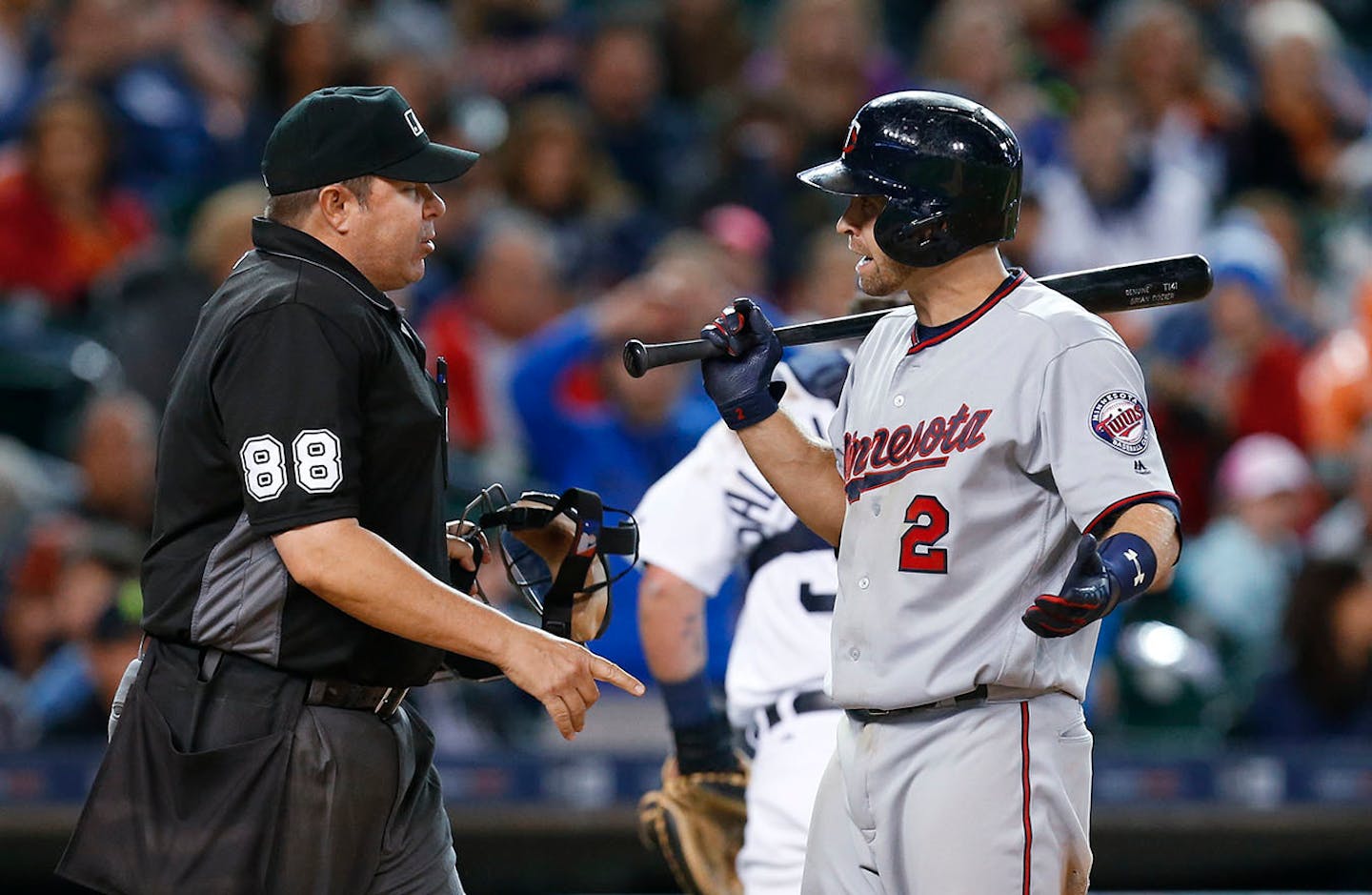 Minnesota Twins' Brian Dozier (2) reacts to a called third strike by umpire Doug Eddings (88) in the seventh inning of a baseball game against the Detroit Tigers, Monday, May 16, 2016 in Detroit.