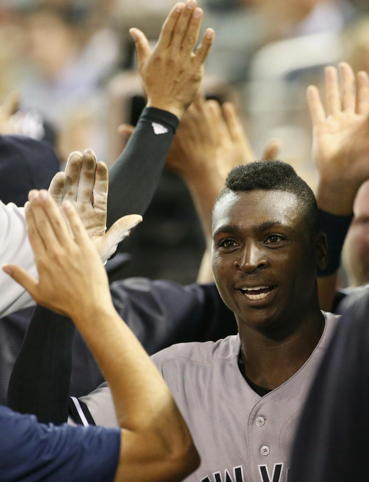 New York Yankees' Didi Gregorius celebrates with teammates in the dugout after his three-run home run off Minnesota Twins relief pitcher Fernando Abad during the seventh inning of a baseball game in Minneapolis, Thursday, June 16, 2016. (AP Photo/Ann Heisenfelt)