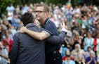 Sen. Scott Dibble, DFL-Minneapolis, got a hug from Monica Meyer, executive director of OutFront Minnesota, at a vigil held at Loring Park in Minneapol