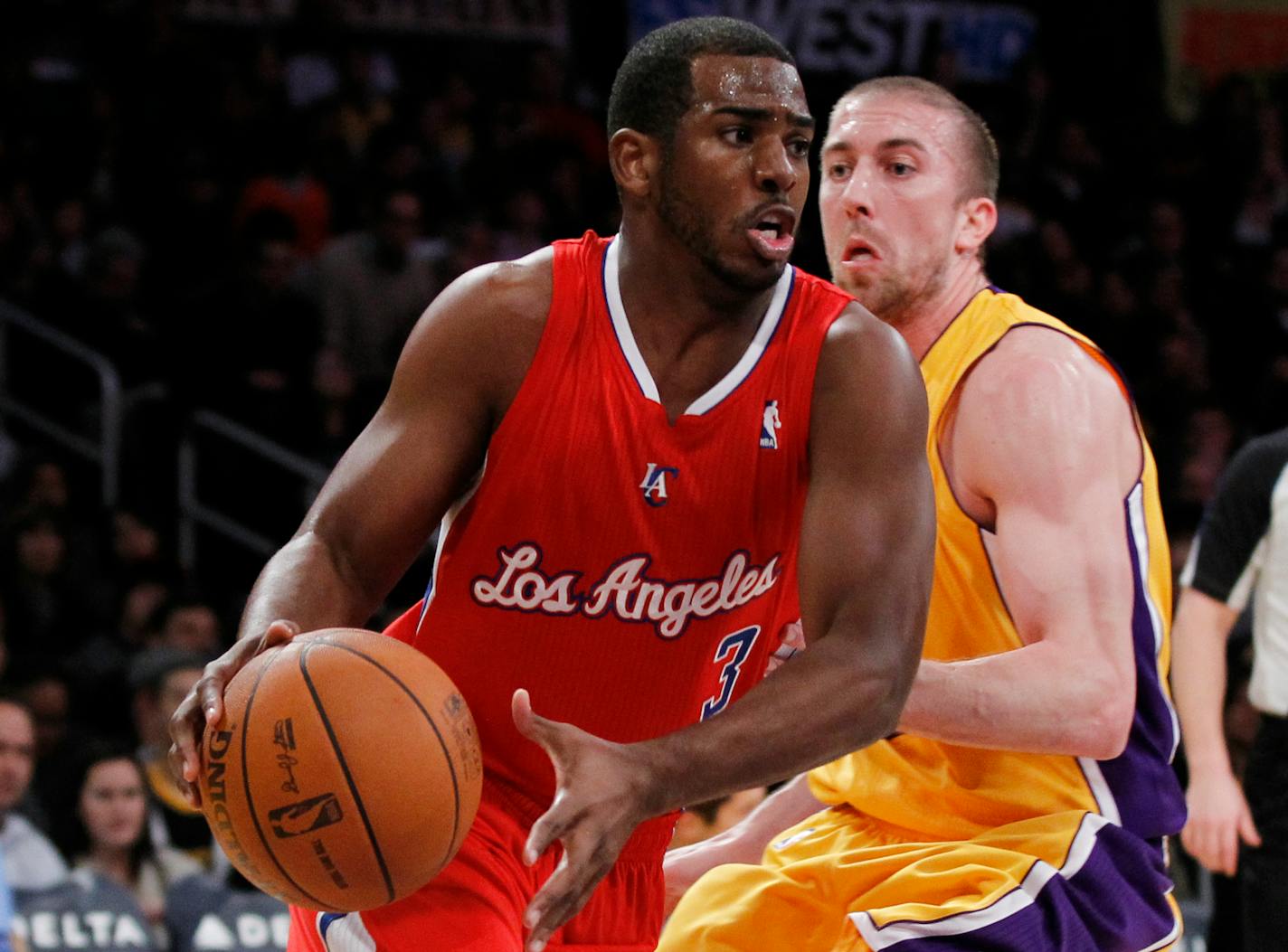 Los Angeles Clippers' Chris Paul, left, drives past Los Angeles Lakers' Steve Blake during the first half of an NBA preseason basketball game in Los Angeles on Monday, Dec. 19, 2010. (AP Photo/Danny Moloshok)