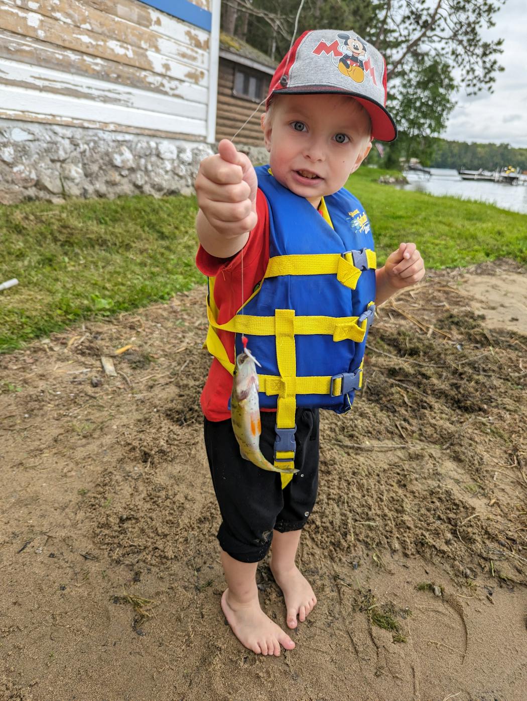 Barrett caught his first fish, dangling a worm and hook from a dock on Pokegama Lake to fool a perch.