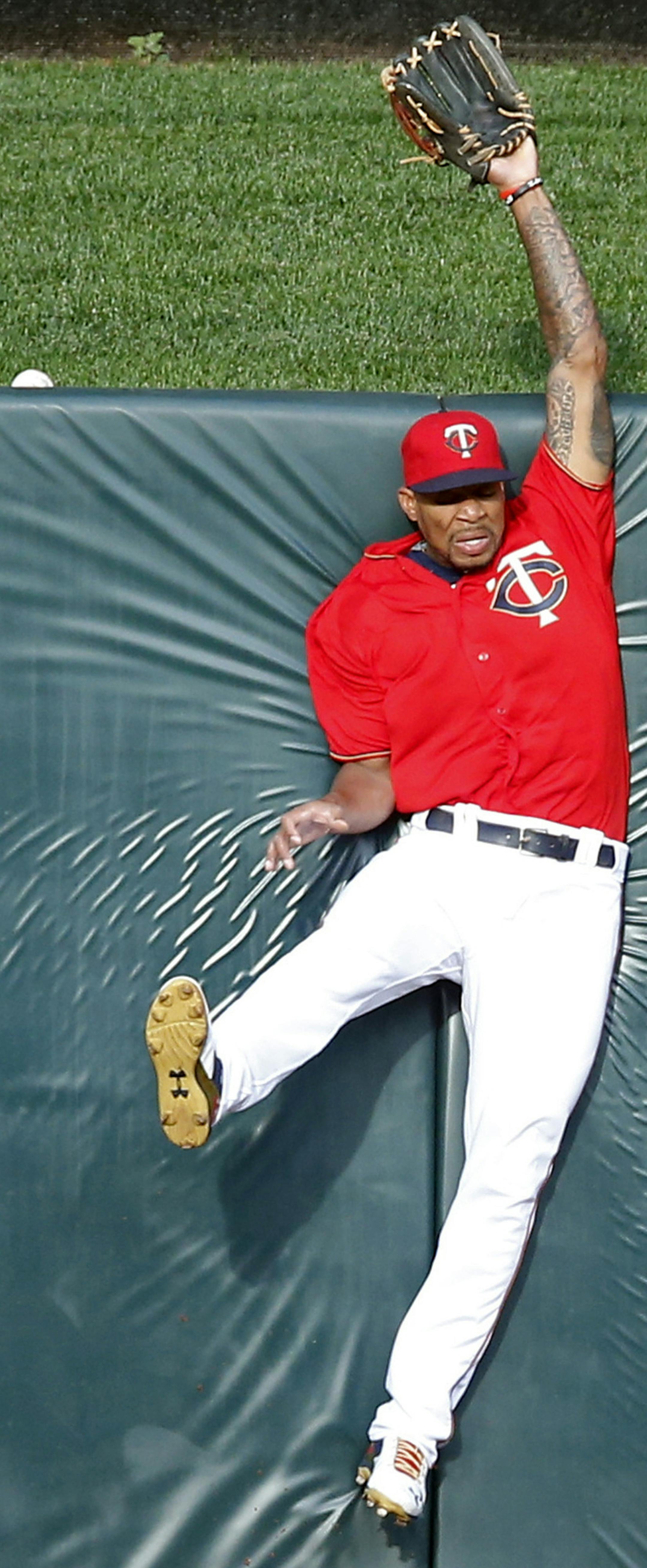 Minnesota Twins center fielder Byron Buxton hits he wall in a futile attempt on a solo home run by Tampa Bay Rays' Evan Longoria in the first inning of a baseball game Friday, June 3, 2016, in Minneapolis. (AP Photo/Jim Mone)