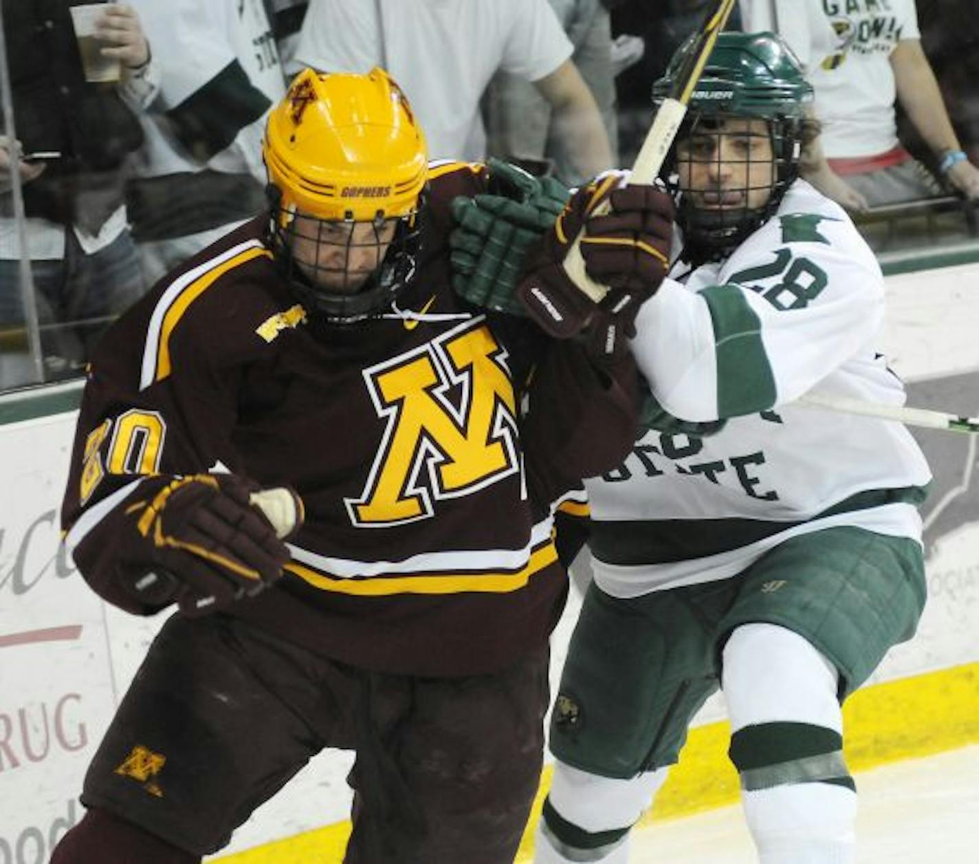 Minnesota's Mark Alt, left, and Bemdji State's Jordan George, right, collide during the first period of a Western Collegiate Hockey Association game Friday March 4, 2011 at the Sanford Center in Bemidji, Minn.