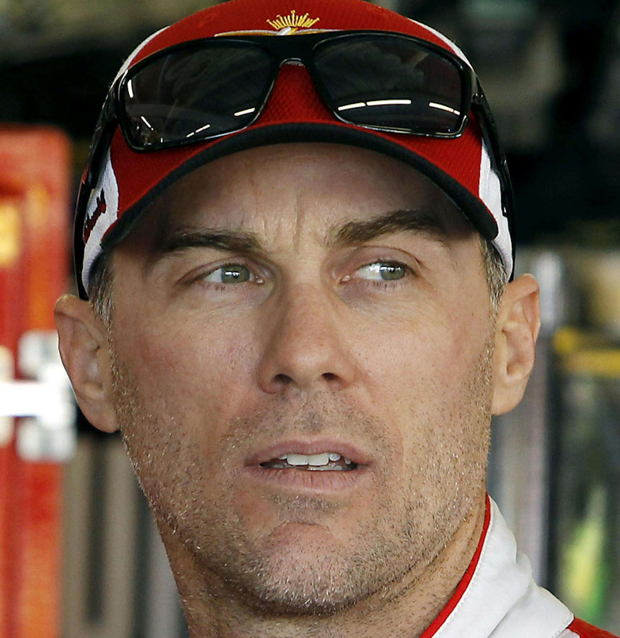Kevin Harvick looks on from the garage area before practice for Sunday's NASCAR Sprint Cup Series auto race at Phoenix International Raceway, Saturday, Nov. 14, 2015 in Avondale, Ariz. Harvick is looking to win his fifth straight race at Phoenix and clinch a spot in the final Chase for the Cup championship race in Homestead, Fla.. (AP Photo/Ralph Freso)