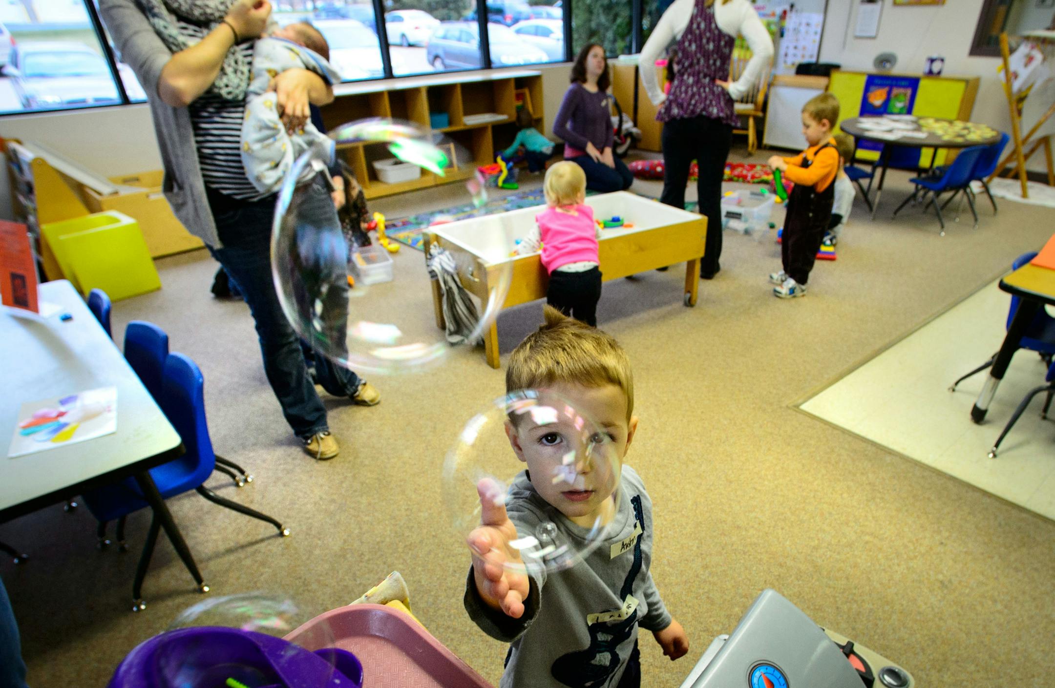 Austin Kitchenmaster, 2, reached for a bubble at the adult education and early childhood center in Apple Valley. The plan to relocate the existing District 196 adult education and early childhood center to another location in Apple Valley is causing controversy among residents there. Wednesday, November 20, 2013. ] GLEN STUBBE * gstubbe@startribune.com EDS, Kitchenmaster is cq