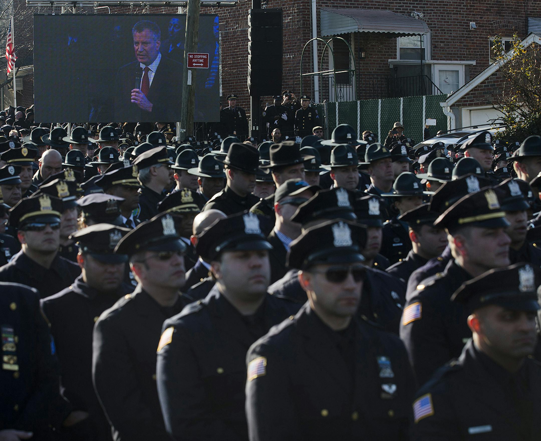 Police officers turn their backs as New York City Mayor Bill de Blasio speaks at the funeral of New York city police officer Rafael Ramos in the Glendale section of Queens, Saturday, Dec. 27, 2014, in New York. Ramos and his partner, officer Wenjian Liu, were killed Dec. 20 as they sat in their patrol car on a Brooklyn street. The shooter, Ismaaiyl Brinsley, later killed himself. (AP Photo/John Minchillo) ORG XMIT: MIN2014122713220567