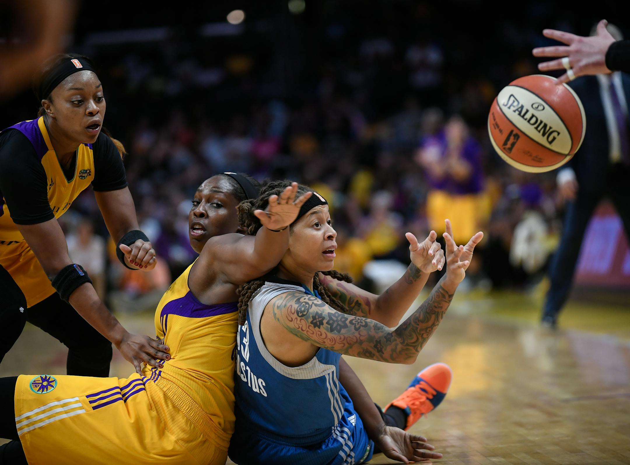 Seimone Augustus (33) passed the ball while being defended by Los Angeles Sparks guard Chelsea Gray