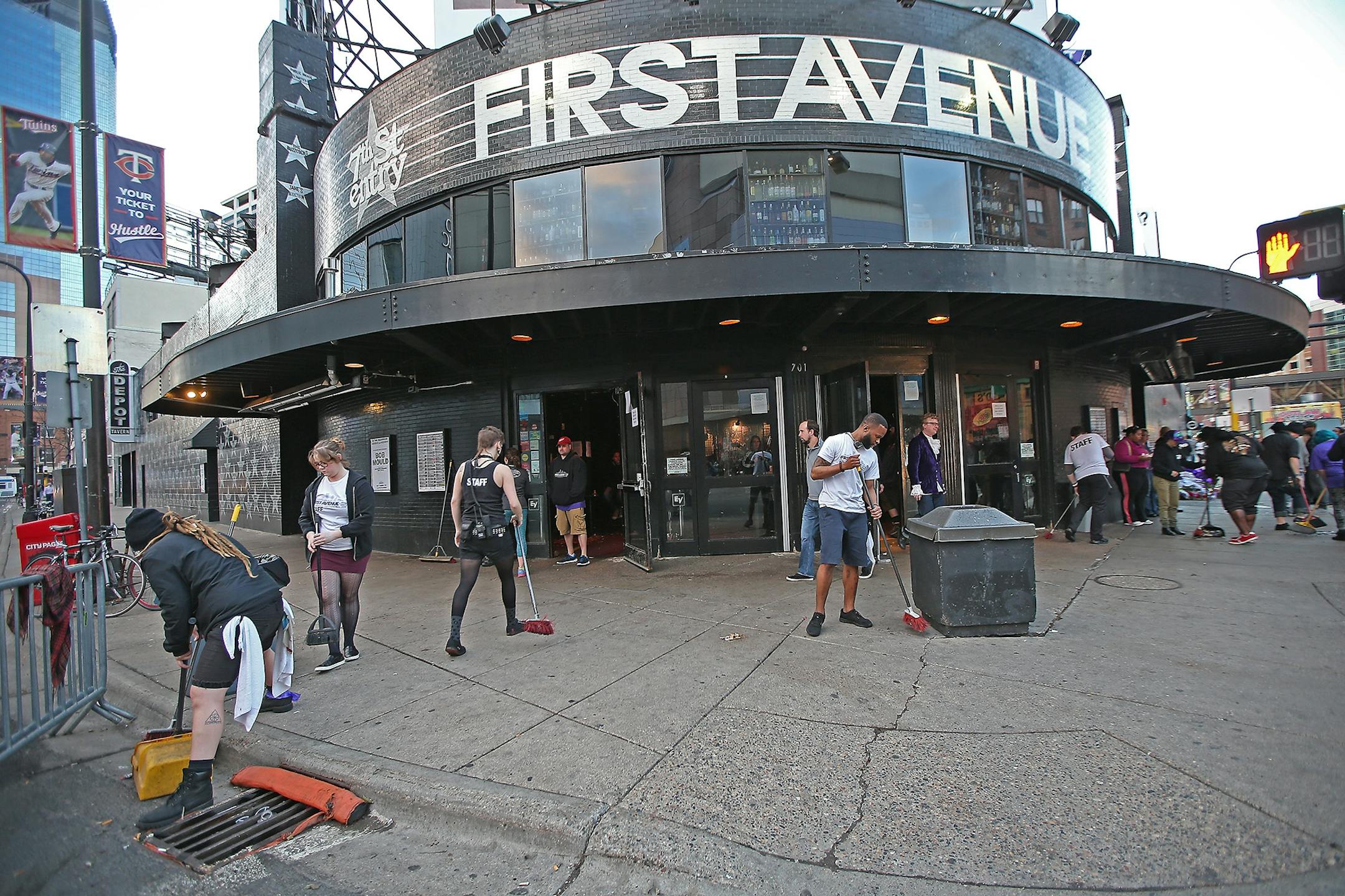 First Avenue staff swept the outside of the building as the last of fans made their way out, Friday, April 22, 2016 in Minneapolis, MN.
