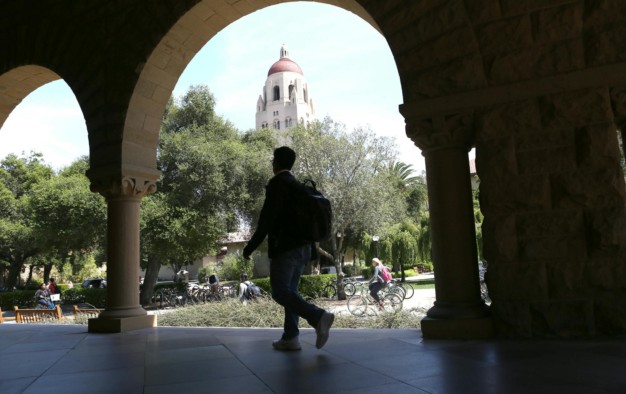 Students and faculty walk on campus at Stanford University in Palo Alto, Calif., April 8, 2014. The university announced on May 6 that it would divest its $18.7 billion endowment of stock in coal-mining companies, becoming the first major university to start to side with a nationwide campaign to purge endowments and pension funds of fossil-fuel investments. (Thor Swift/The New York Times) NYTCREDIT: