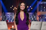 This image released by Disney shows Jenn Tran, a contestant on "The Bachelor." (John Fleenor/Disney via AP). She has long black, wavy hair and is wear