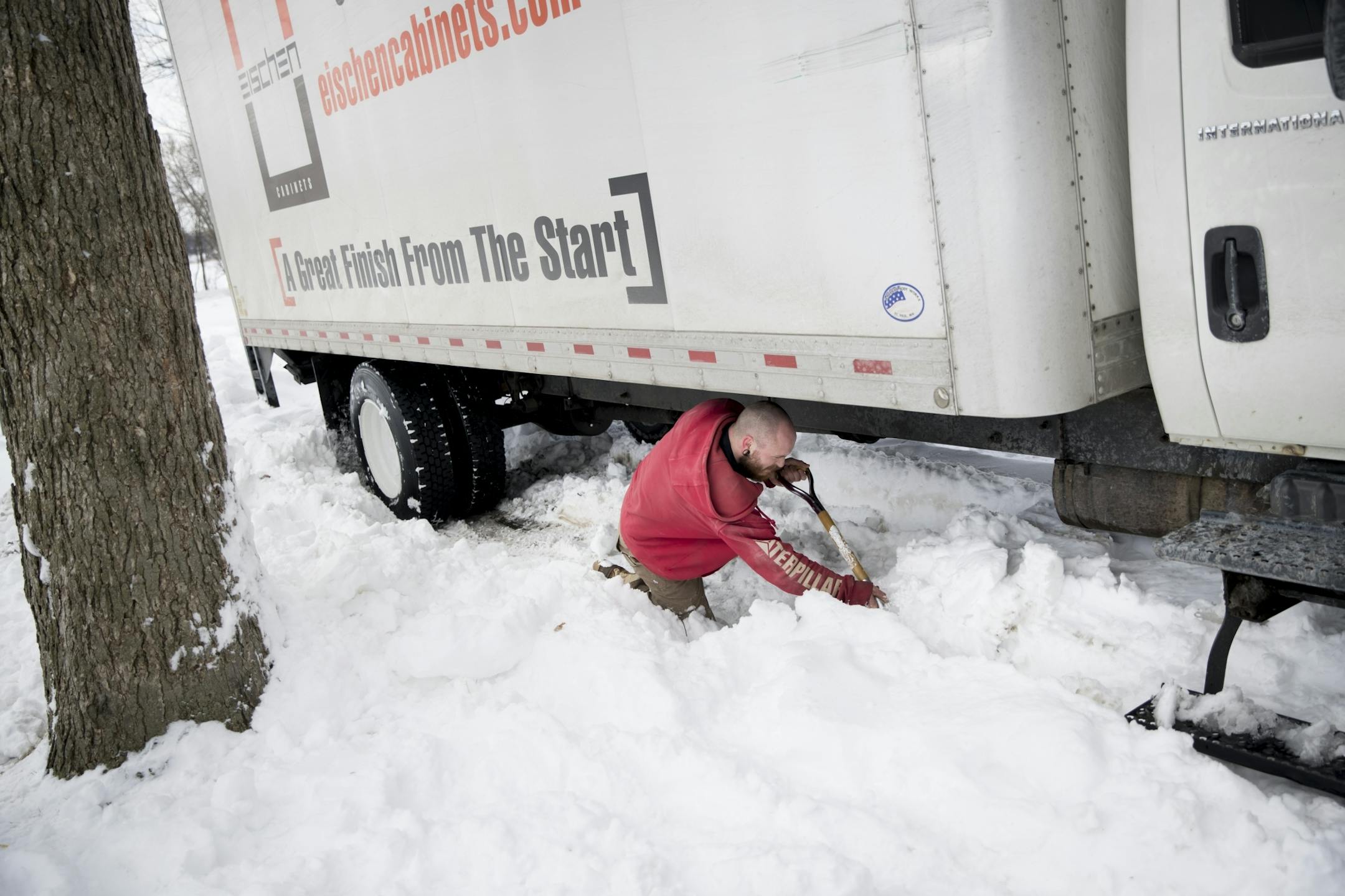 Luke Damsgard spent almost an hour trying to dig his truck out of his parking spot after a delivery on Monday, April 16, 2018 in Minneapolis, Minn.