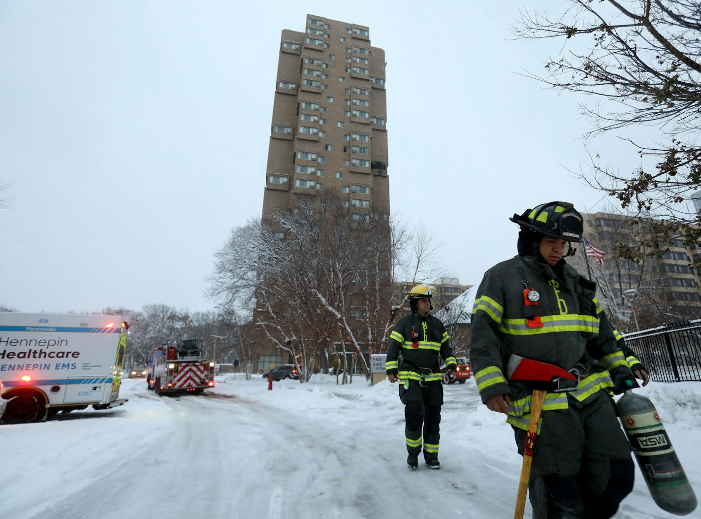 Residents of a south Minneapolis high rise were evacuated early Wednesday after a fire broke out on the 14th floor of the building, killing five people. Here, Minneapolis firefighters leave Wednesday, Nov. 27, 2019, in Minneapolis.