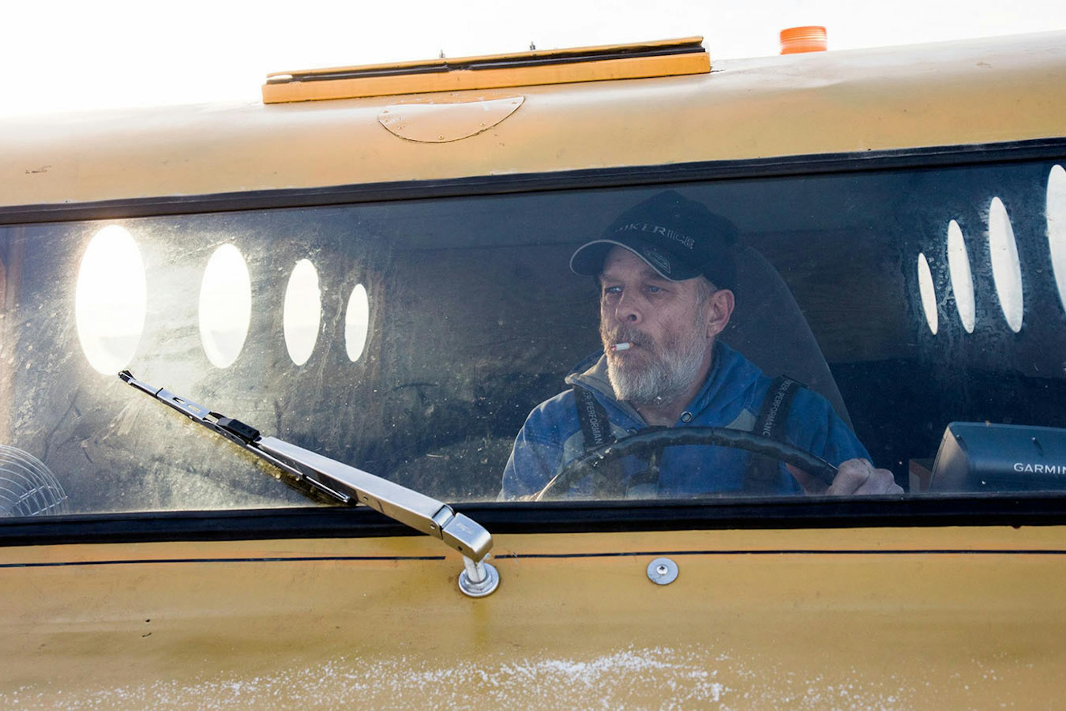 Joe Anderson driving the 1952 bombardier, which he uses nearly every day, to the next ice house to check in with his customers.
