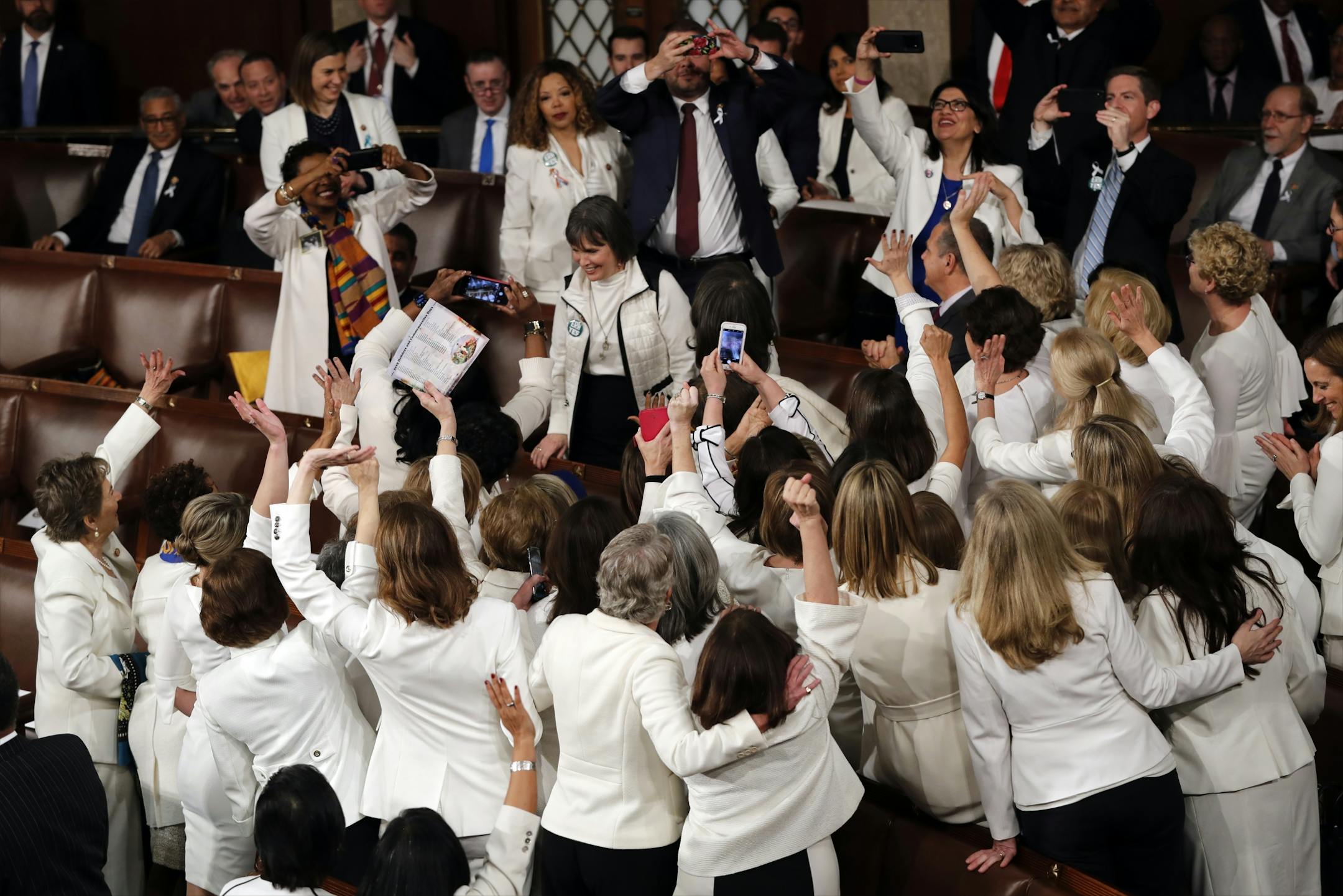 Democratic members of Congress take photos before President Donald Trump delivers his State of the Union address to a joint session of Congress on Capitol Hill in Washington, Tuesday, Feb. 5, 2019.