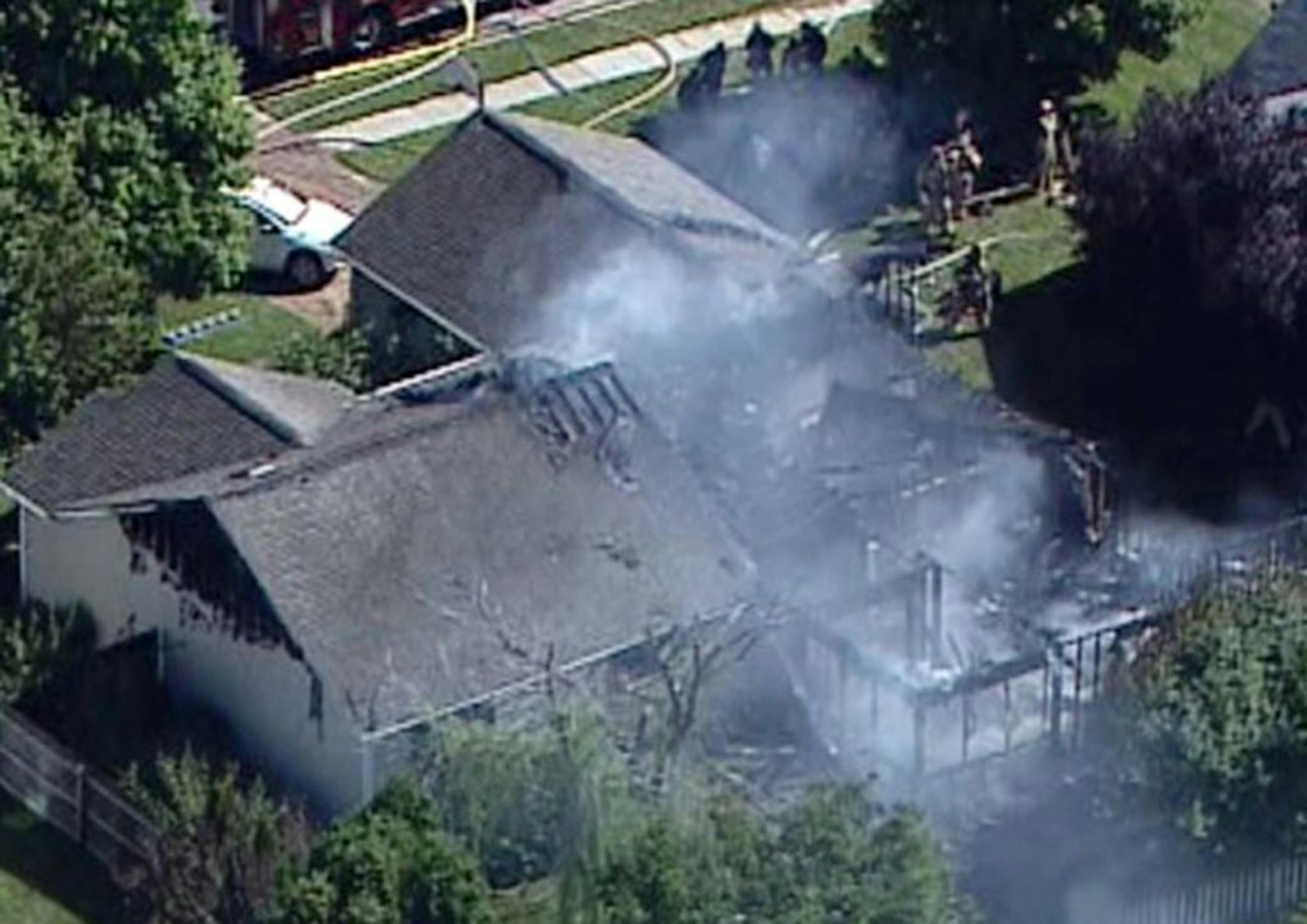 In this frame grab from video provided by Chopper 8, WISH TV, smoke rises from a house in Columbus, Ind., after a small plane crashed into the home injuring two people who were on the plane. A woman who lives in the house and was home at the time of the crash was not injured. (AP Photo/Chopper 8, WISH TV) MANDATORY CREDIT