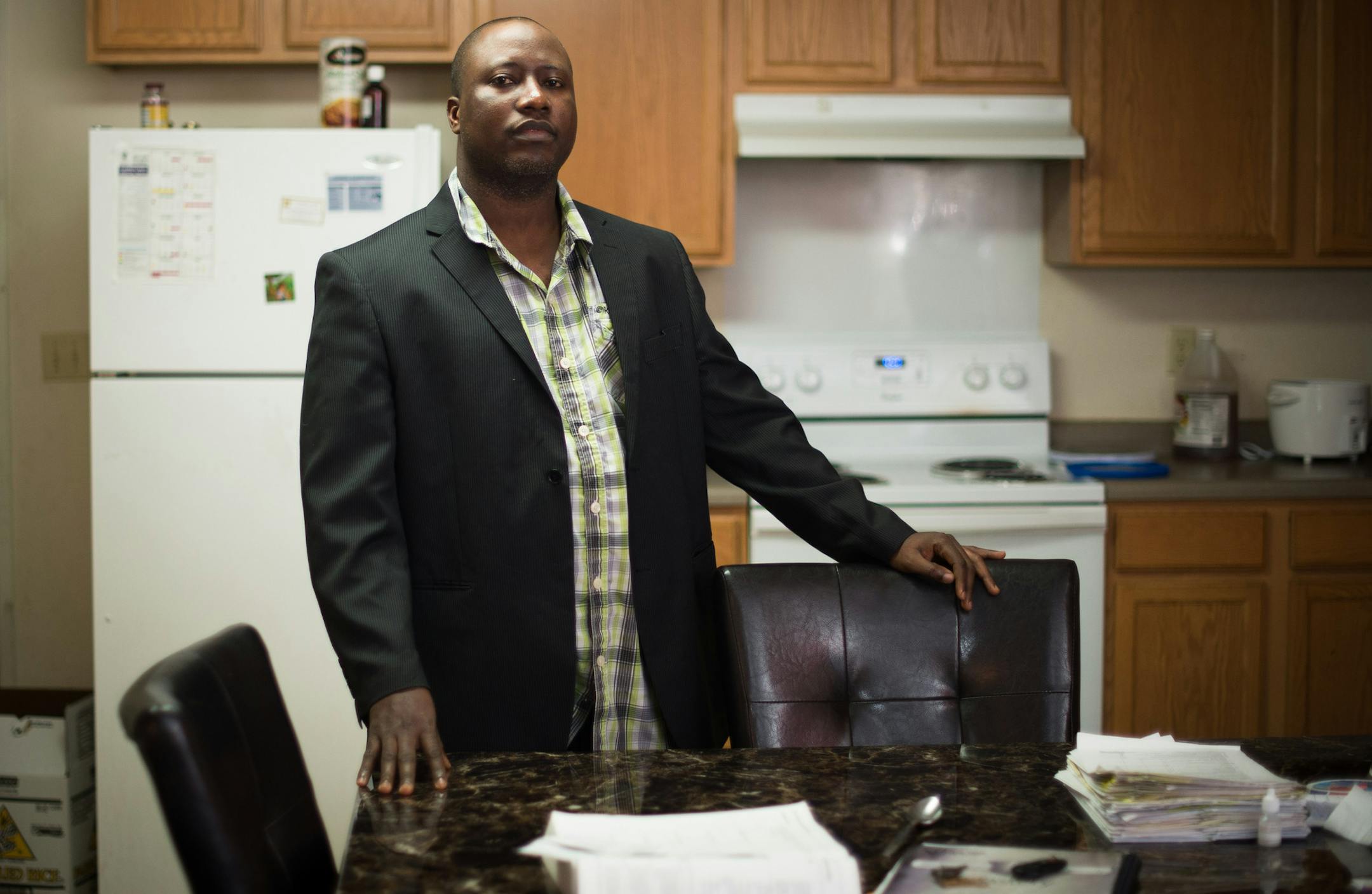 Jacob Mayson is pictured in his home in Ramsey Friday, Nov. 7, 2014. Mayson has been working to get his two sons and fiancé home safely from Liberia. ] AARON LAVINSKY • aaron.lavinsky@startribune.com Jacob Mayson has been working to get his fiancé and two children home safely from Liberia after they were stranded as a result of the Ebola outbreak in July. Mason was photographed in his home Friday, Nov. 7, 2014 in Ramsey.