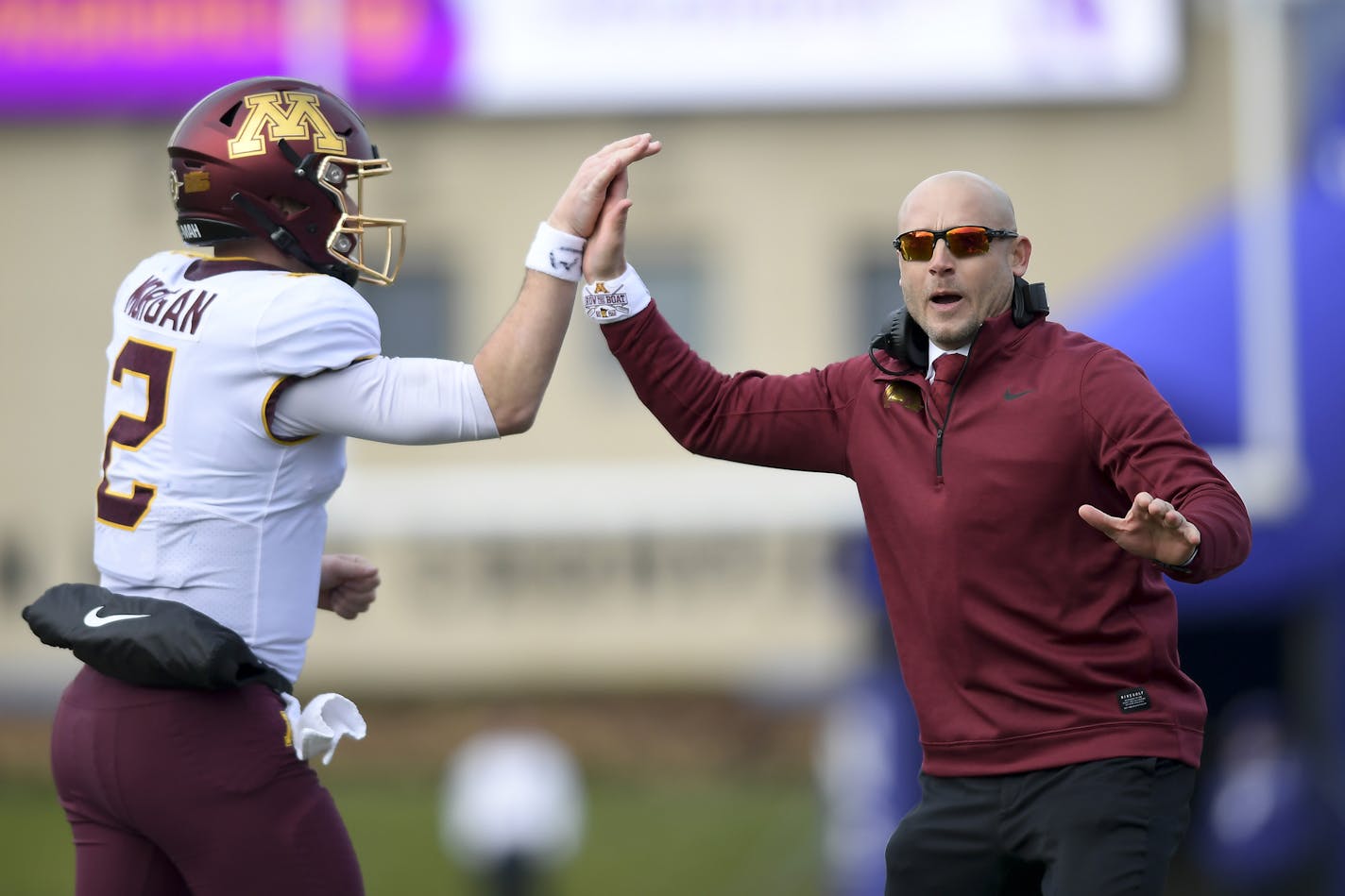 Minnesota Gophers quarterback Tanner Morgan (2) high fived head coach P.J. Fleck after Morgan's fourth quarter touchdown pass to wide receiver Tyler Johnson (6). The Minnesota Gophers played the Northwestern Wildcats on Saturday, Nov. 23, 2019 at Ryan Field in Evanston, Ill. (Aaron Lavinsky/Minneapolis Star Tribune/TNS) ORG XMIT: 1497980