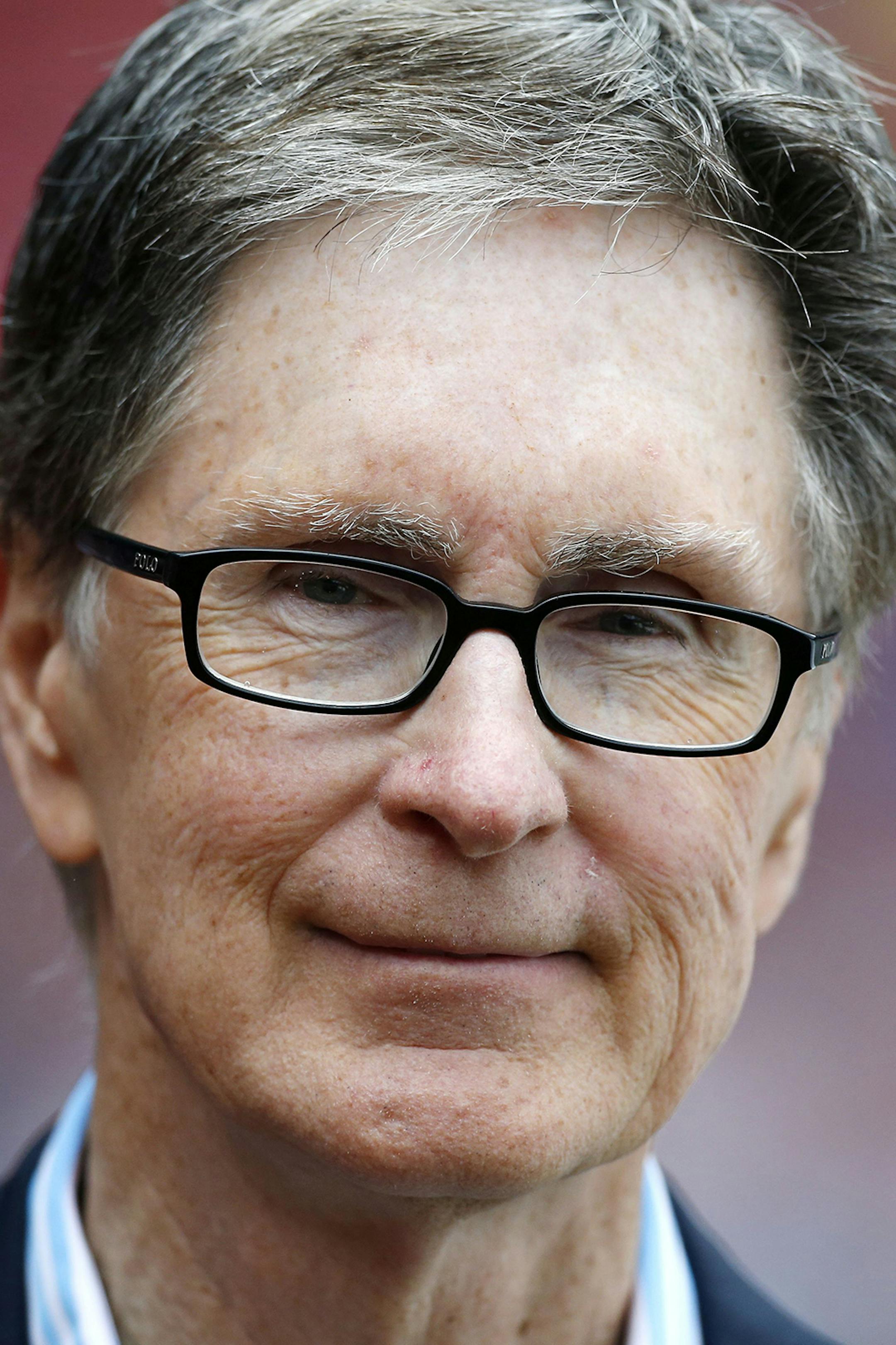 FILE - Boston Red Sox owner John Henry stands on the field before a baseball game in Boston, in this May 11, 2013 file photo. The principal owner of the Boston Red Sox has entered into an agreement to buy The Boston Globe. The Globe says the impending purchase marks businessman John Henry's "first foray into the financially unsettled world of the news media." It said early Saturday Aug. 3, 2013 the deal will give Henry the 141-year-old newspaper, its websites and affiliated companies. (AP Photo/