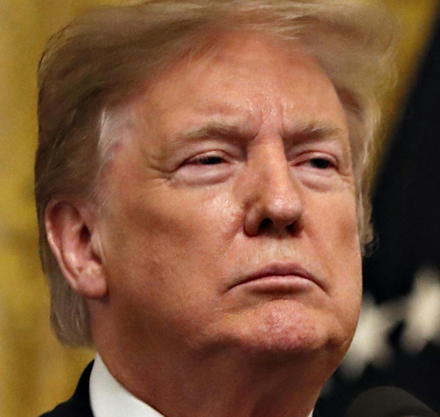 President Donald Trump adjusts his blazer as he speaks before signing an executive order requiring colleges to certify that their policies support free speech as a condition of receiving federal research grants, Thursday March 21, 2019, in the East Room of the White House in Washington. (AP Photo/Jacquelyn Martin)