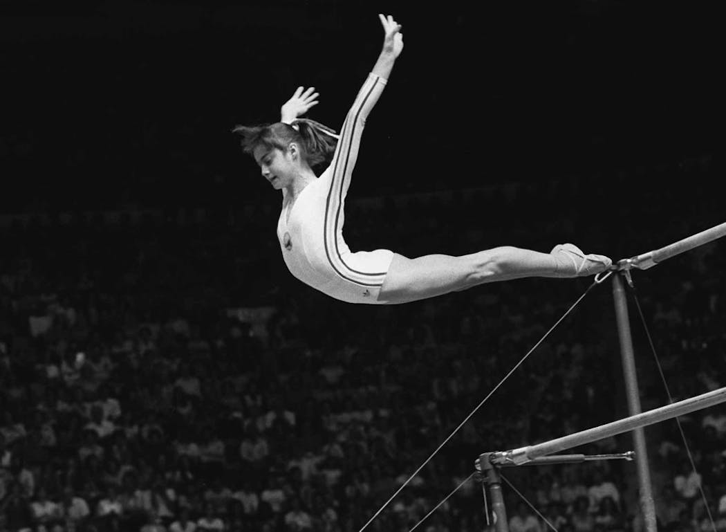 Nadia Comaneci dismounted from the uneven parallel bars during a perfect 