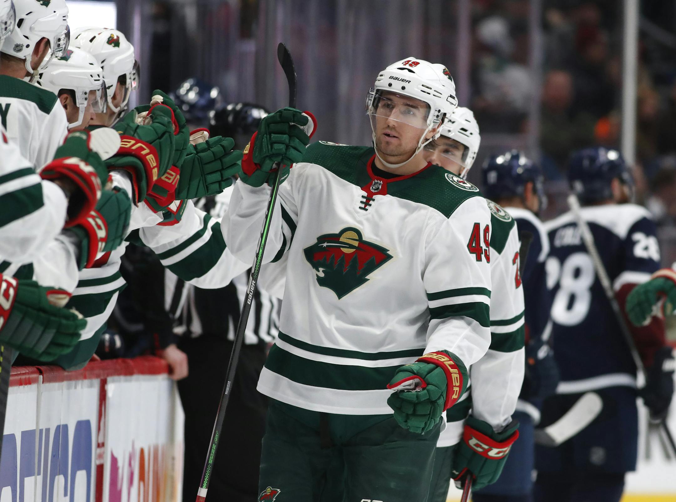 Minnesota Wild center Victor Rask, right, is congratulated as he passes the team box after scoring the go-ahead goal against the Colorado Avalanche in the third period of an NHL hockey game Friday, Dec. 27, 2019, in Denver. (AP Photo/David Zalubowski)