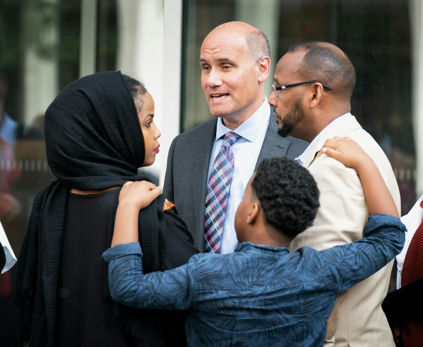 Attorney Jordan Kushner talked with family members of his client Mohamed Farah. On the right are Farah's parents Abdi Hamid Farah and mother Ayan Farah. Center left is sister and younger brother Abdi Rahim Farah. ] GLEN STUBBE &#x2022; glen.stubbe@startribune.com Thursday, June 14, 2018 Protesters wore orange ponchos in solidarity with the three men being who were convicted in plotting to join ISIS. The men are appearing before a three-judge federal appeals court panel Thursday morning. Proteste