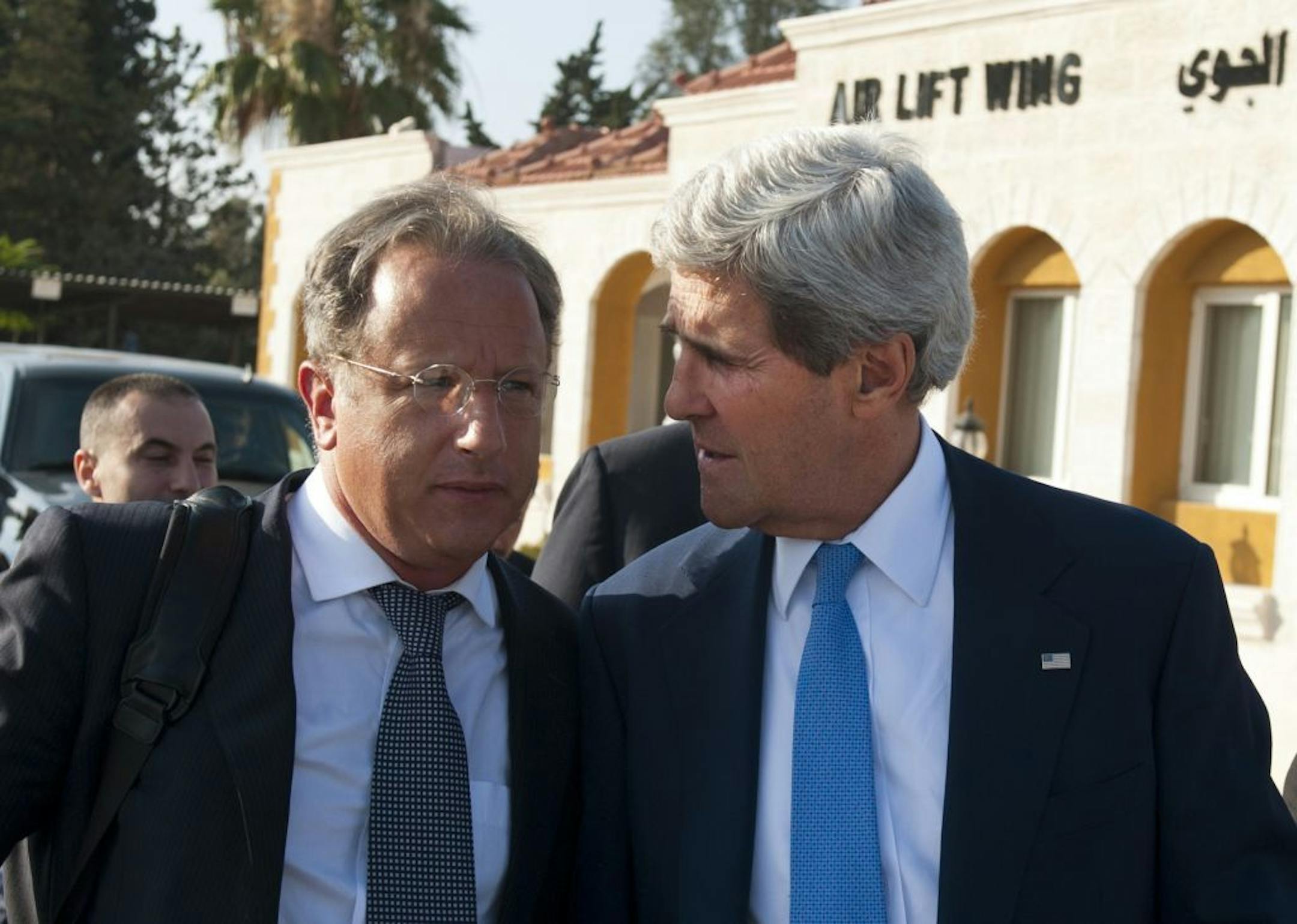 July 19, 2013: U.S. Secretary of State John Kerry, right, chats with Deputy Special Envoy for Middle East Peace Frank Lowenstein while walking to board a flight on in Amman, Jordan.