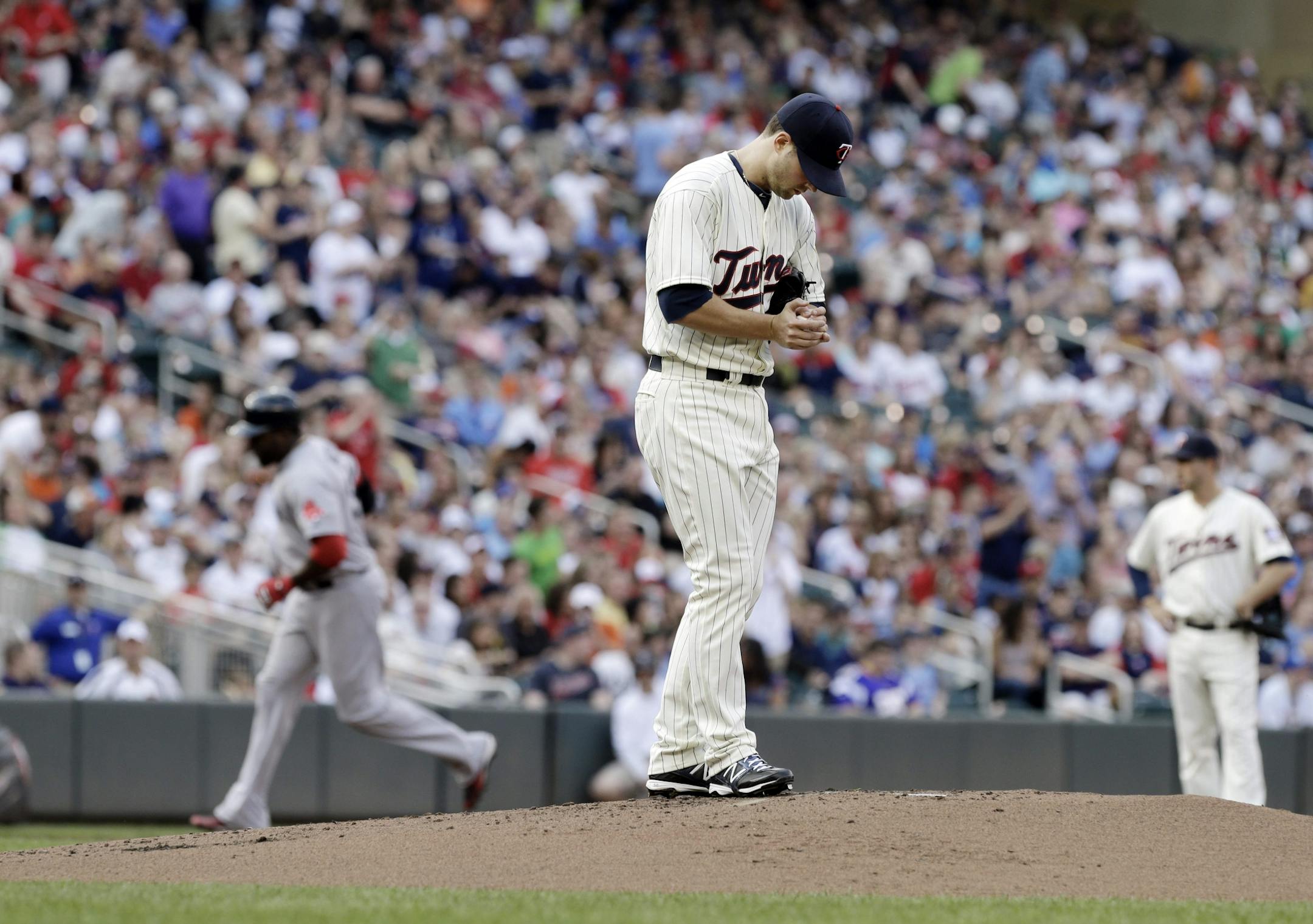 Twins pitcher Scott Diamond looked down at the mound as the Red Sox's David Ortiz, left, ran the bases on his three-run home run off Diamond in the first inning Saturday.