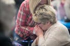 Photo by Elizabeth Flores: Longtime Minneapolis City Council Member Barb Johnson gave her sister, Therese VanBlarcom, a kiss on the hand after the fir