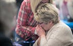 Photo by Elizabeth Flores: Longtime Minneapolis City Council Member Barb Johnson gave her sister, Therese VanBlarcom, a kiss on the hand after the fir