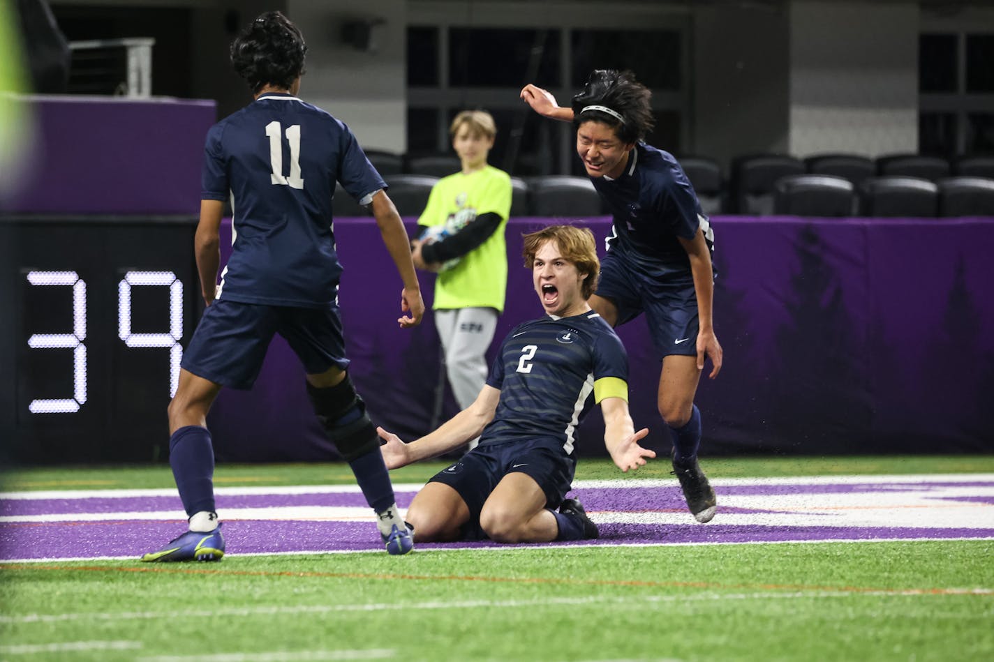 St. Paul Academy's Nathan Cohen (2) slides in celebration of his first half goal giving the Spartans a 2-0 lead at halftime. Photo by Cheryl A. Myers, SportsEngine