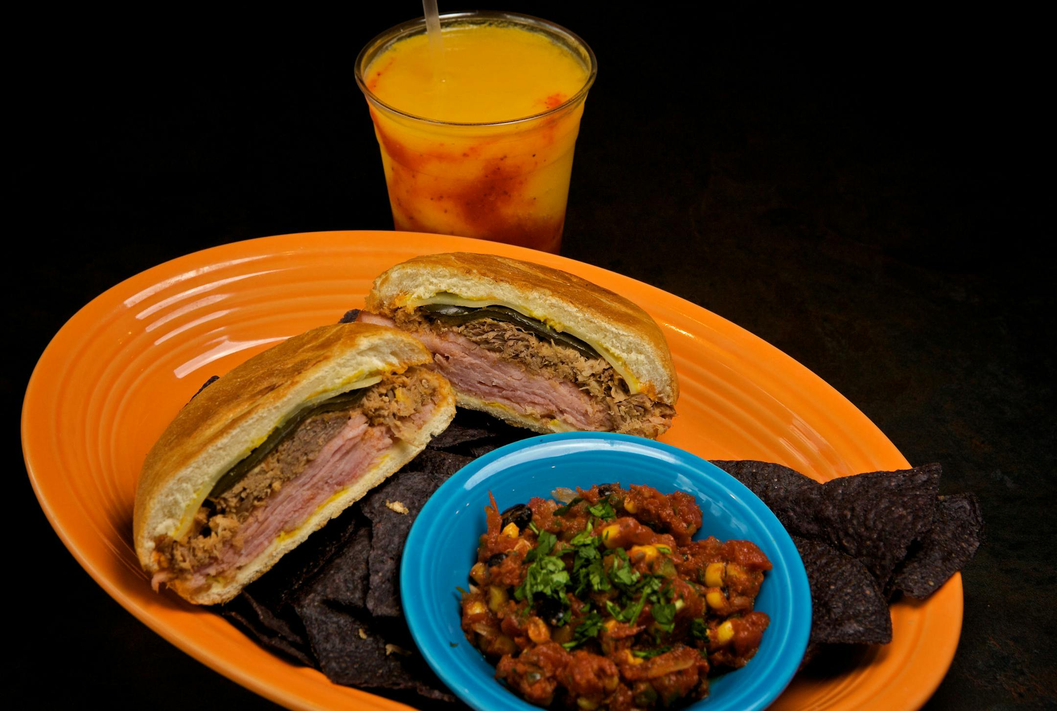 La Luz Cafe in Apple Valley serves a Cuban-style pressed sandwich called the Cubano Poblano with pork, ham, pickled pepper, Swiss cheese and mustard, with chips and salsa on the side. The smoothie has mangoes and strawberries.
