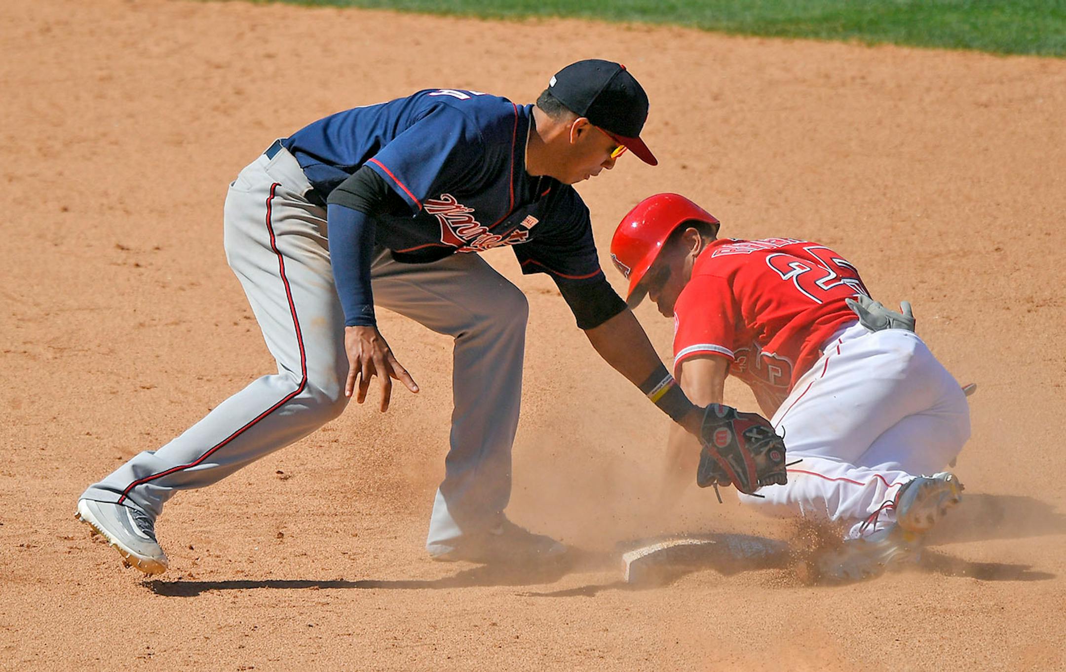 Los Angeles Angels' Ben Revere, right, is tagged out by Minnesota Twins shortstop Ehire Adrianza while trying to steal second during the ninth inning of a baseball game, Sunday, June 4, 2017, in Anaheim, Calif. Revere was initially called safe, but the call was overturned after review which ended the game.