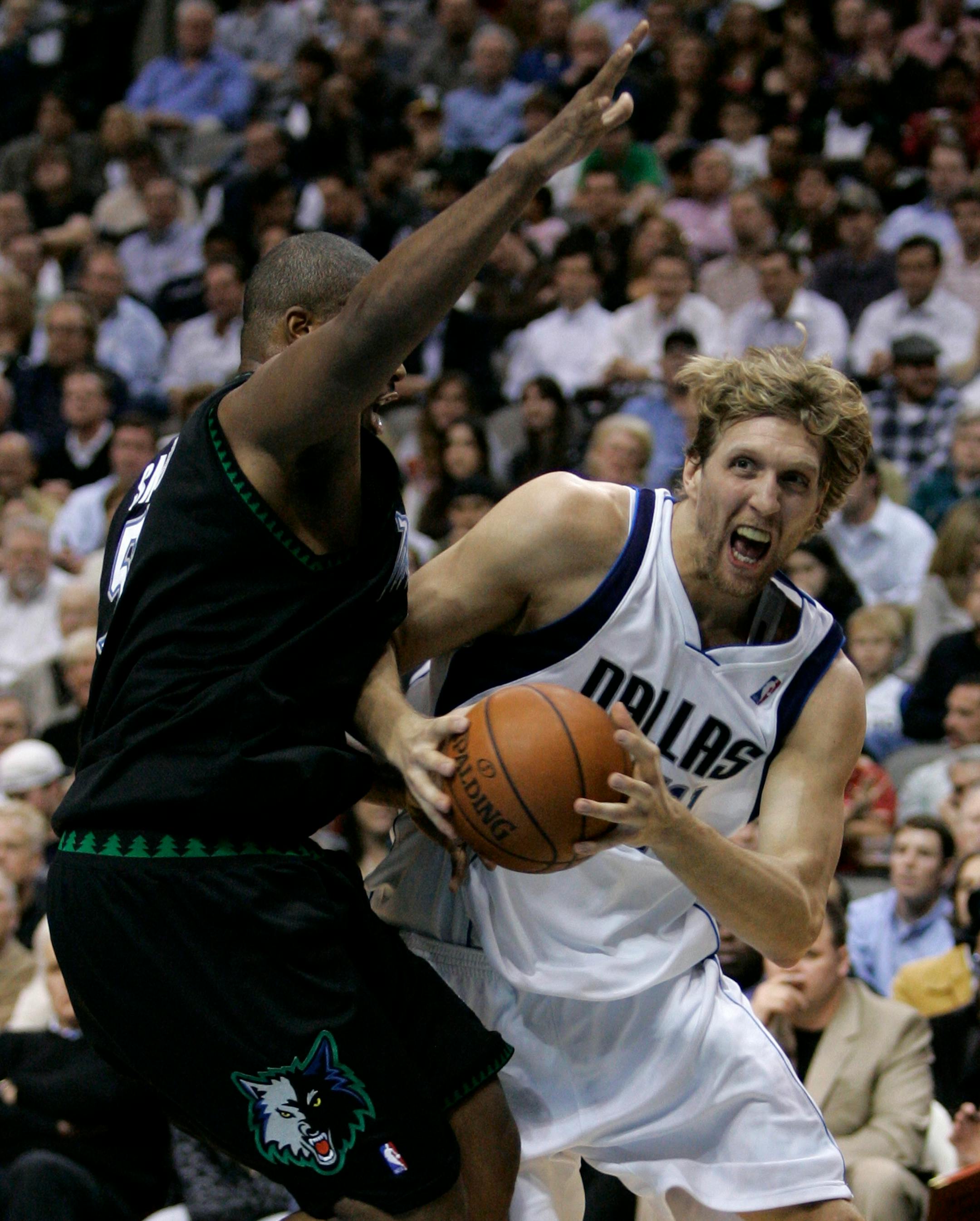 Dallas Mavericks forward Dirk Nowitzki, right, of Germany, drives past Minnesota Timberwolves forward Craig Smith, left, for a shot-attempt during the first half of an NBA basketball game in Dallas, Wednesday, Nov. 28, 2007. (AP Photo/Tony Gutierrez)