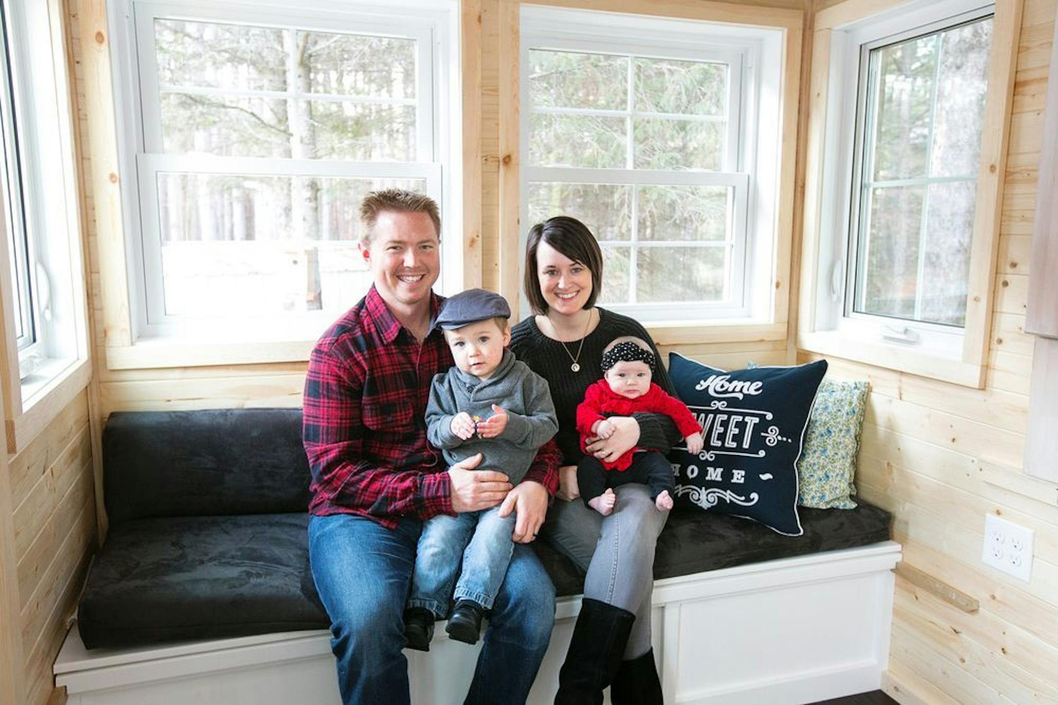 Zac and Caitlin Hogan and their children Finn and Piper inside their tiny house.