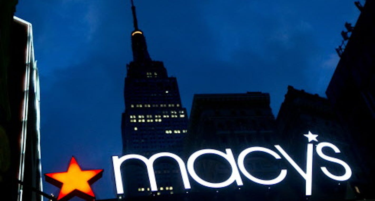 In this Nov. 21, 2013 photo, with the Empire State building in the background, the Macy's logo is illuminated on the front of the department store in New York. Macy's Inc. on Tuesday, May 5, 2015 announced it has named its new discount stores Macy's Backstage, and says first of the four test stores will open this fall in New York City. (AP Photo/Mark Lennihan, File)