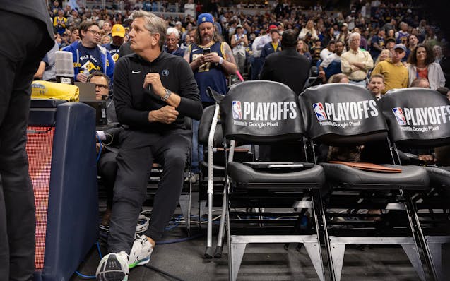 Wolves coach Chris Finch sat on the bench before the start of Game 1 vs. the Nuggets on Saturday in Denver.